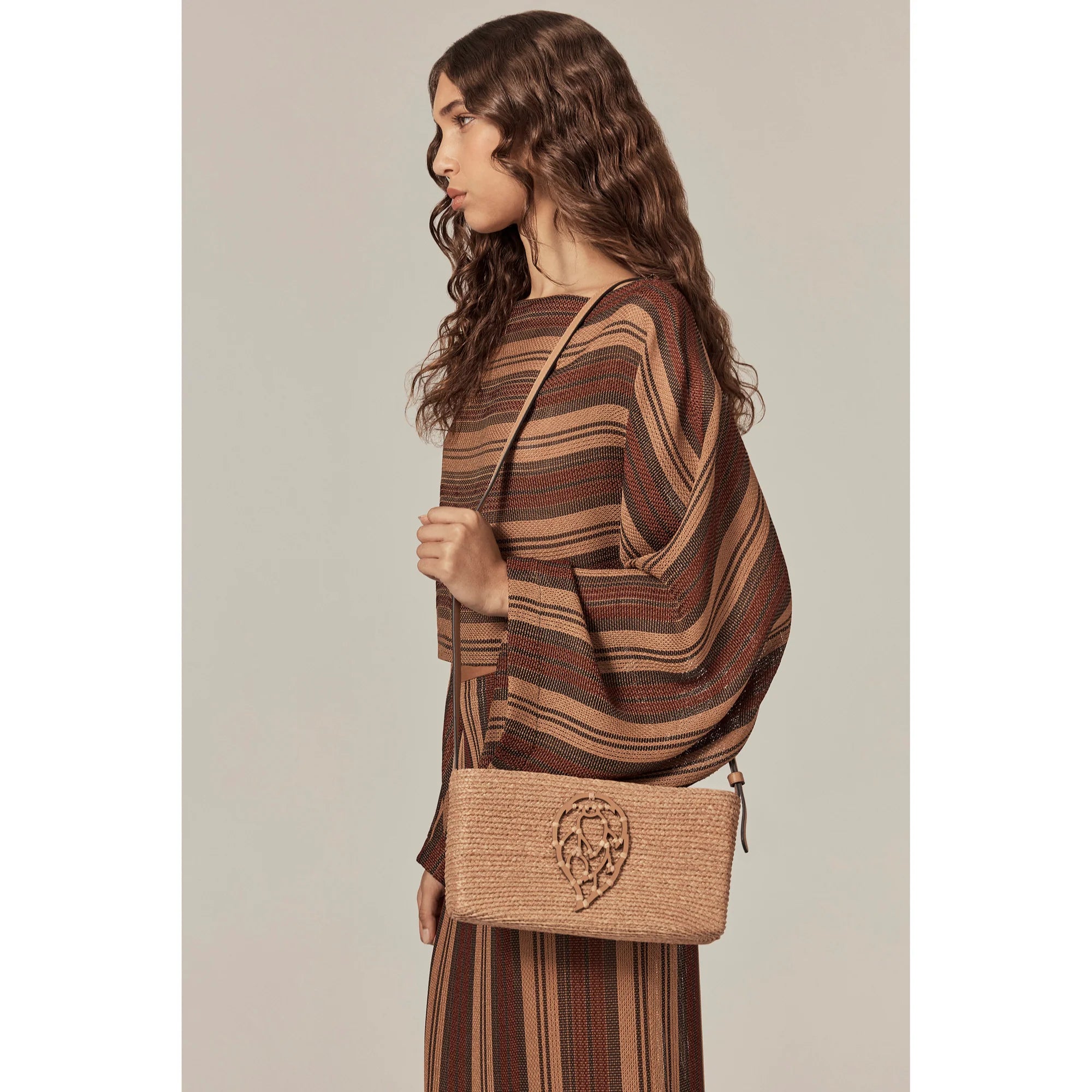 model holding bag Dawn Raffia Crossbody by Helen Kaminski