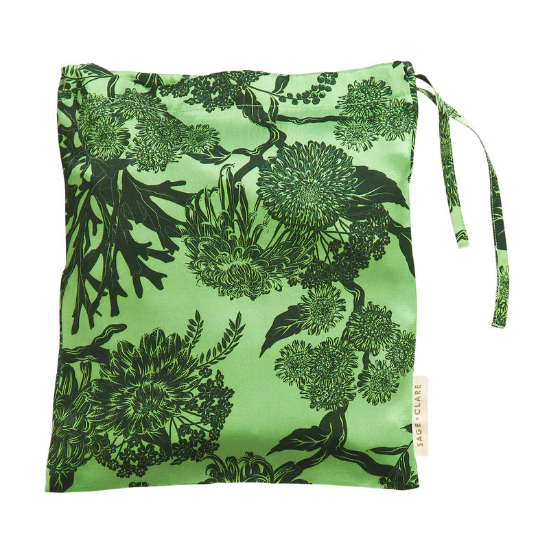 Green drawstring bag with black floral pattern on a white background