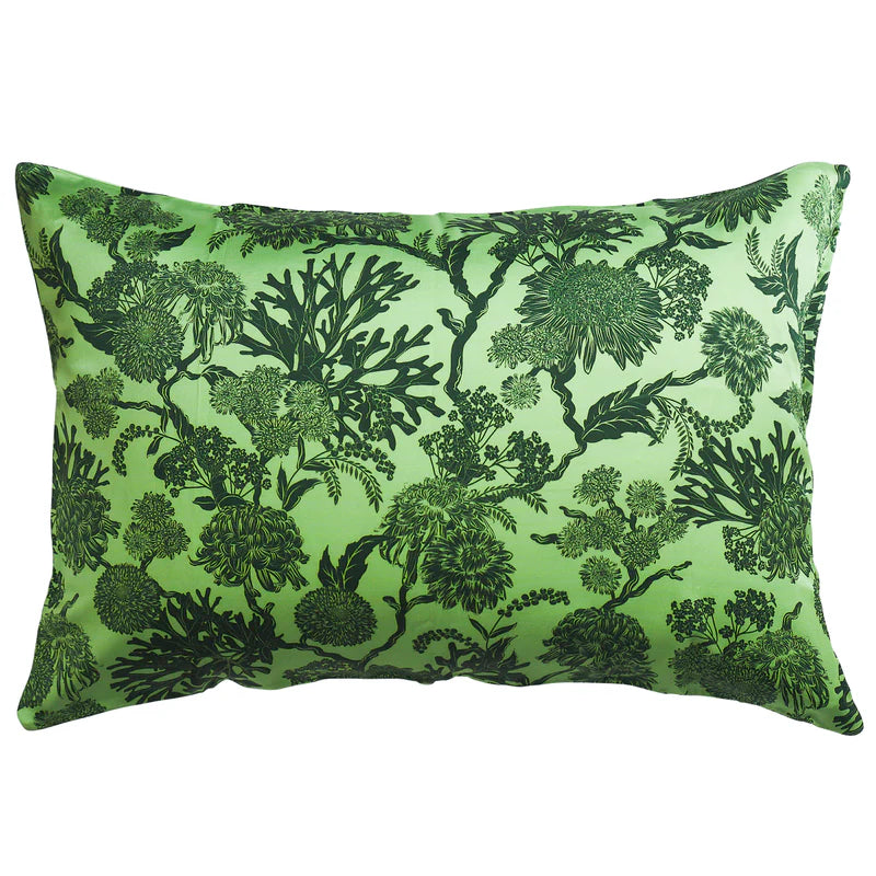 Green pillow with black floral pattern on a white background