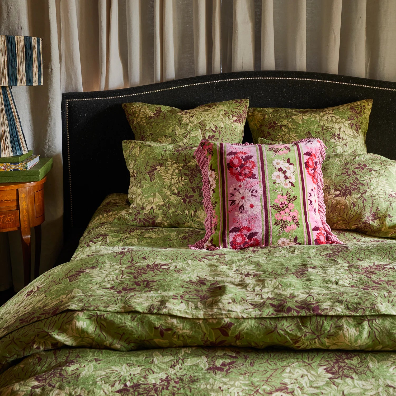 Devi Velvet Cushion Rosewater by Sage and Clare displayed on a bed