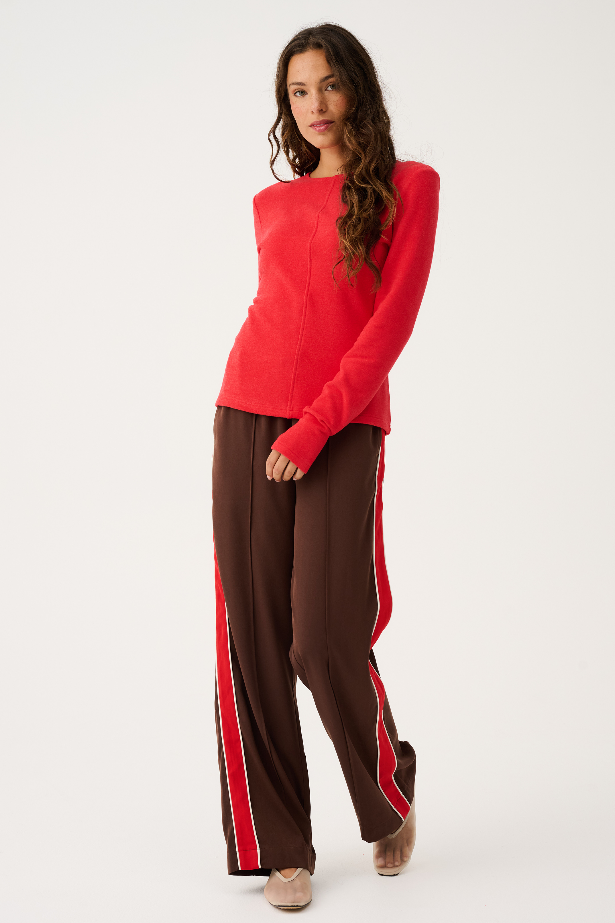 Front view of Dusty Pant in truffle brown with red side stripe detail showing elastic waistband and relaxed fit