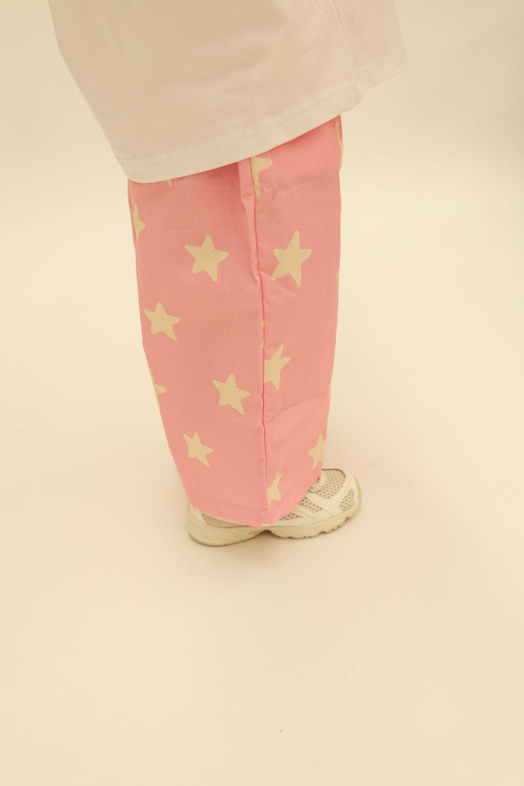 Front styling shot of Dusty Star Pants in pink with yellow stars paired with matching sweatshirt