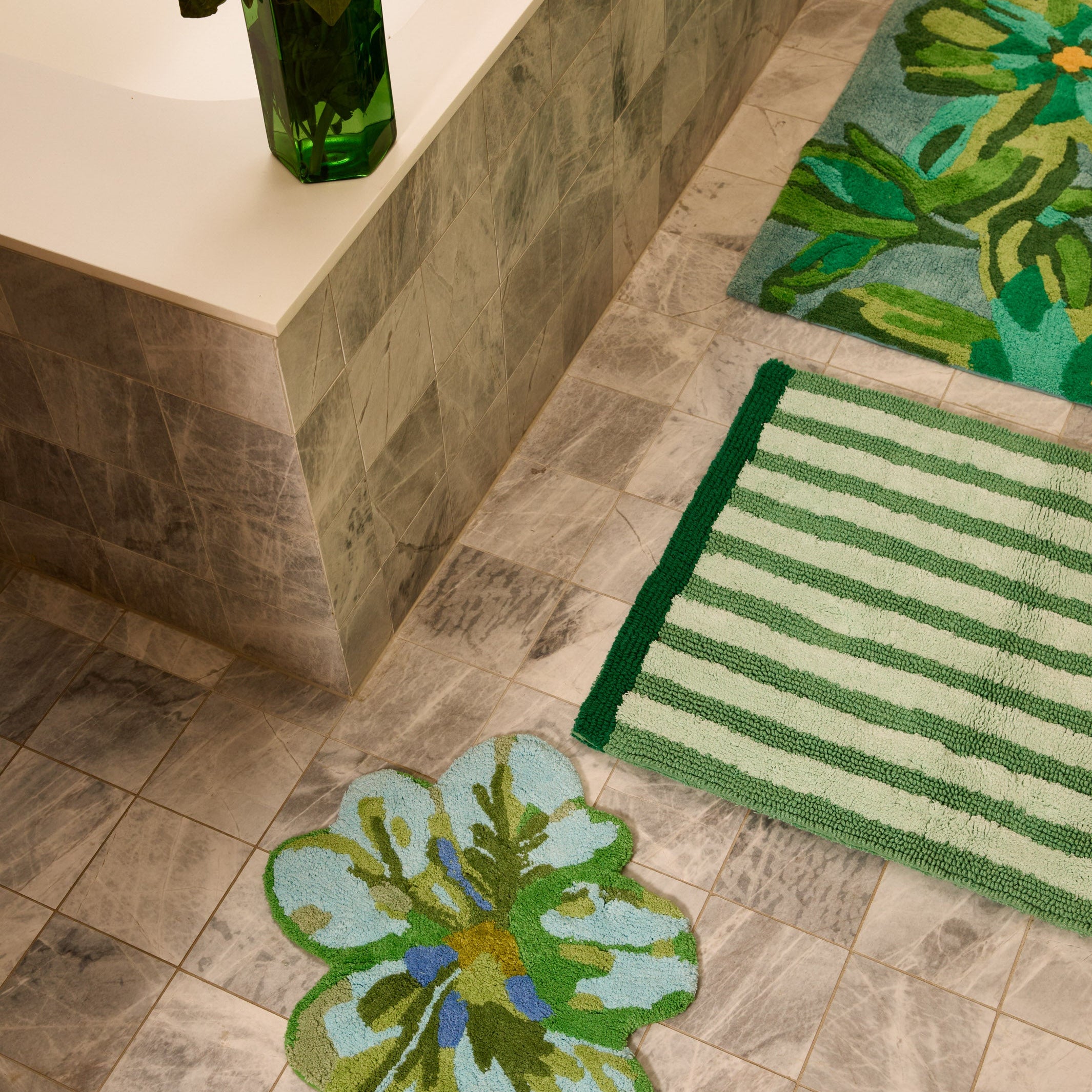 Dutch Floral Green Bath Mat positioned in luxury bathroom with marble surfaces and floral accents