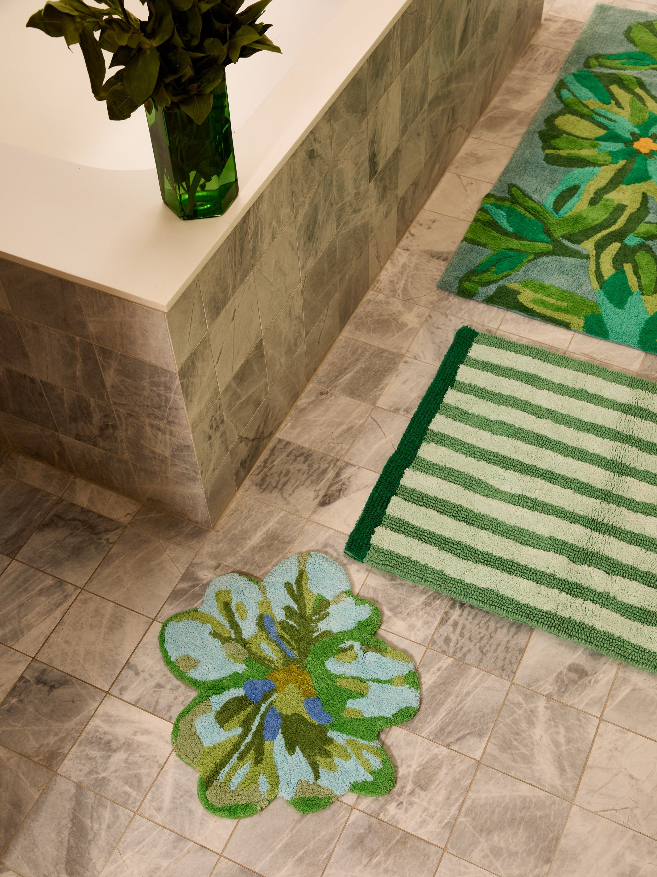 Dutch Floral Green Bath Mat positioned in luxury bathroom with marble surfaces and floral accents