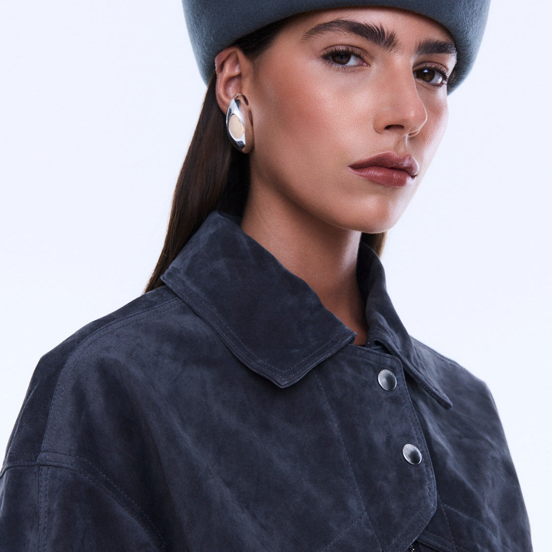 Close-up of Emma Utility Suede Jacket showing navy suede texture and silver snap button details on collar