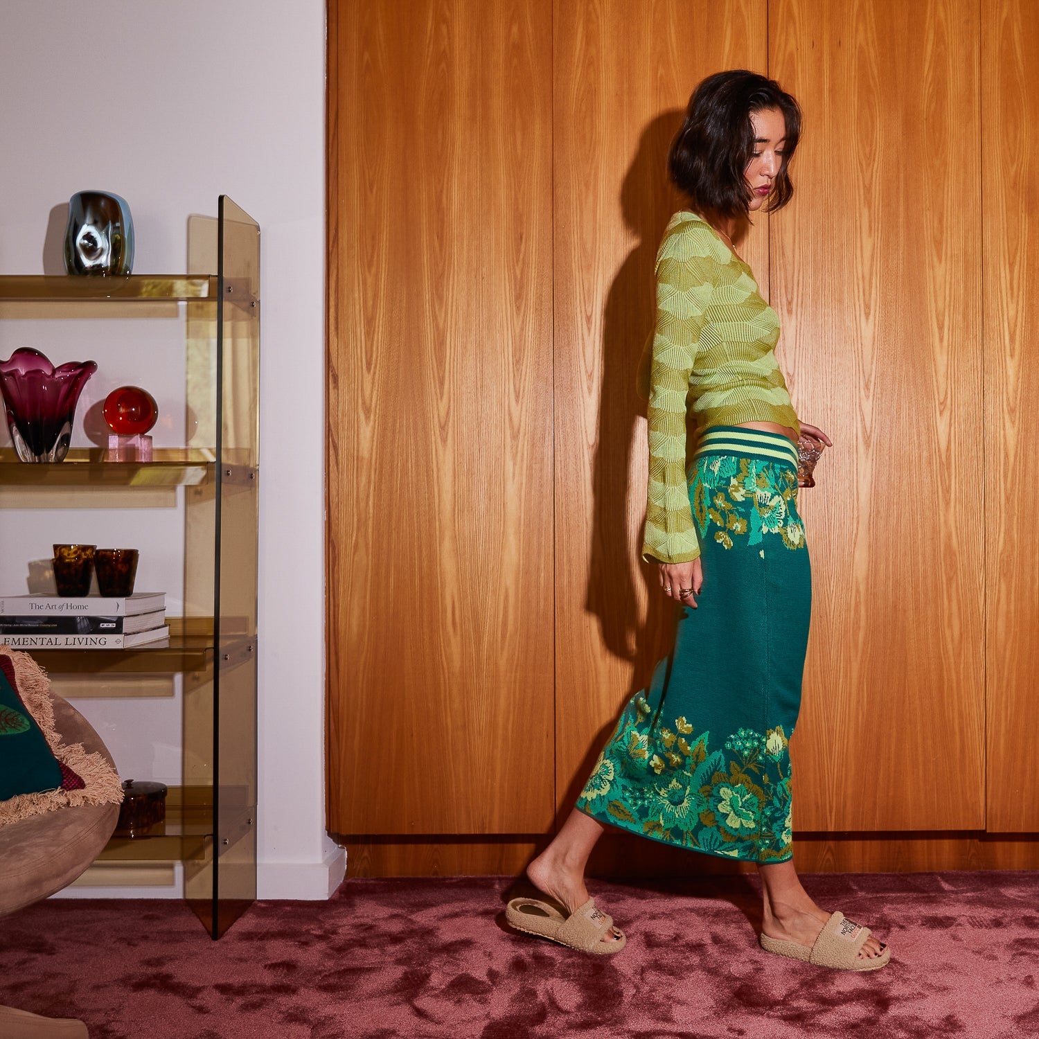 Model posing in Sage Clare Eliza Knit Maxi Skirt with teal base and botanical print design
