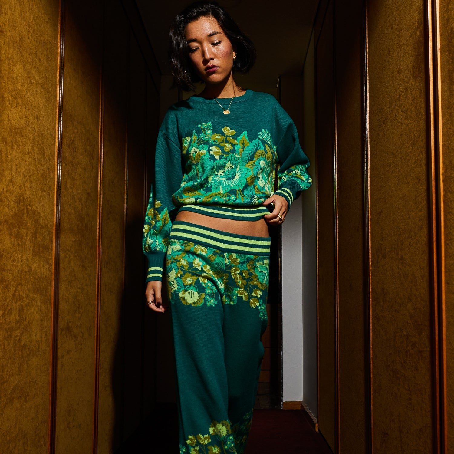 Full length view of Eliza Knit Sweater in teal with vibrant floral pattern and matching pants
