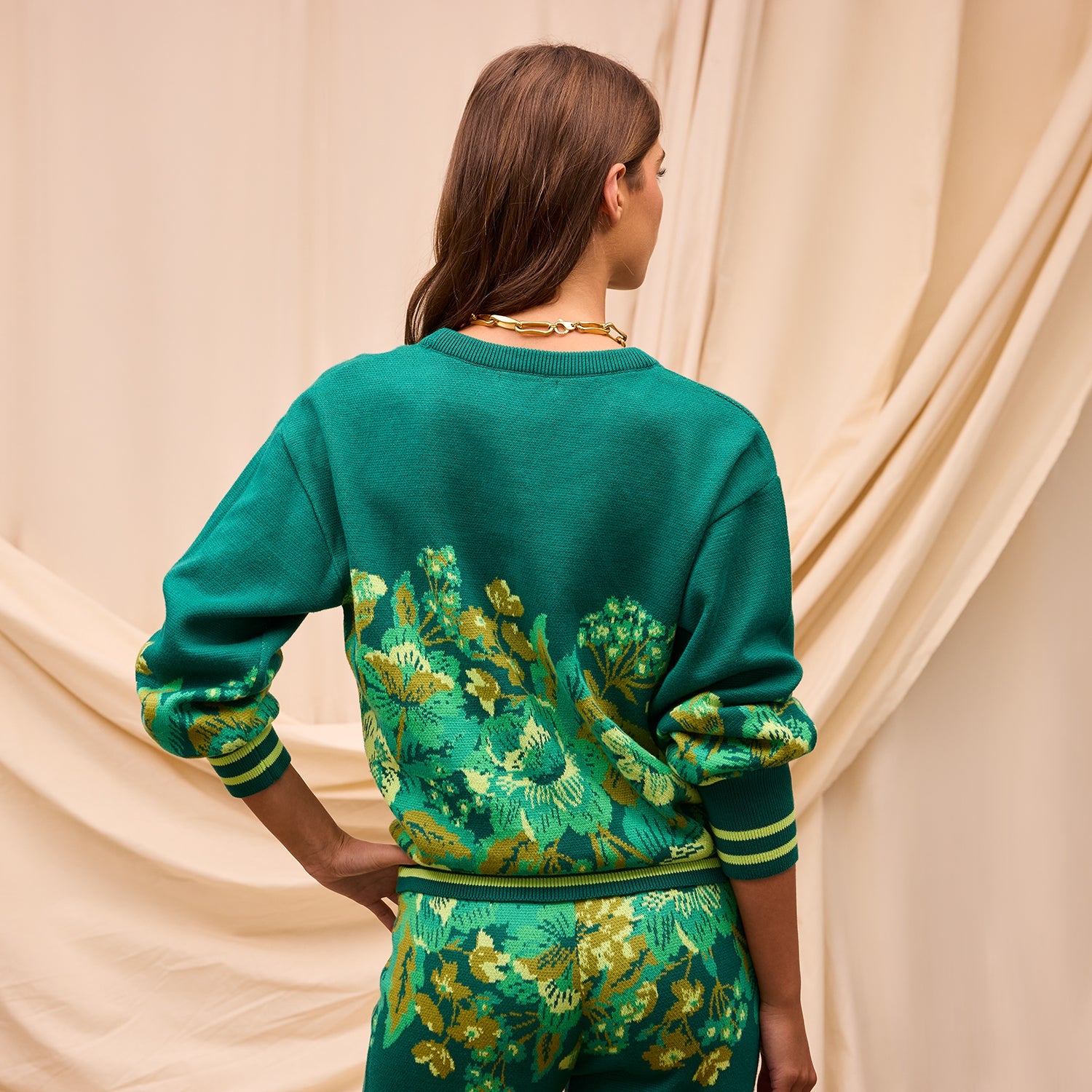 Back view of Eliza Knit Sweater displaying botanical motif and ribbed neckline detail