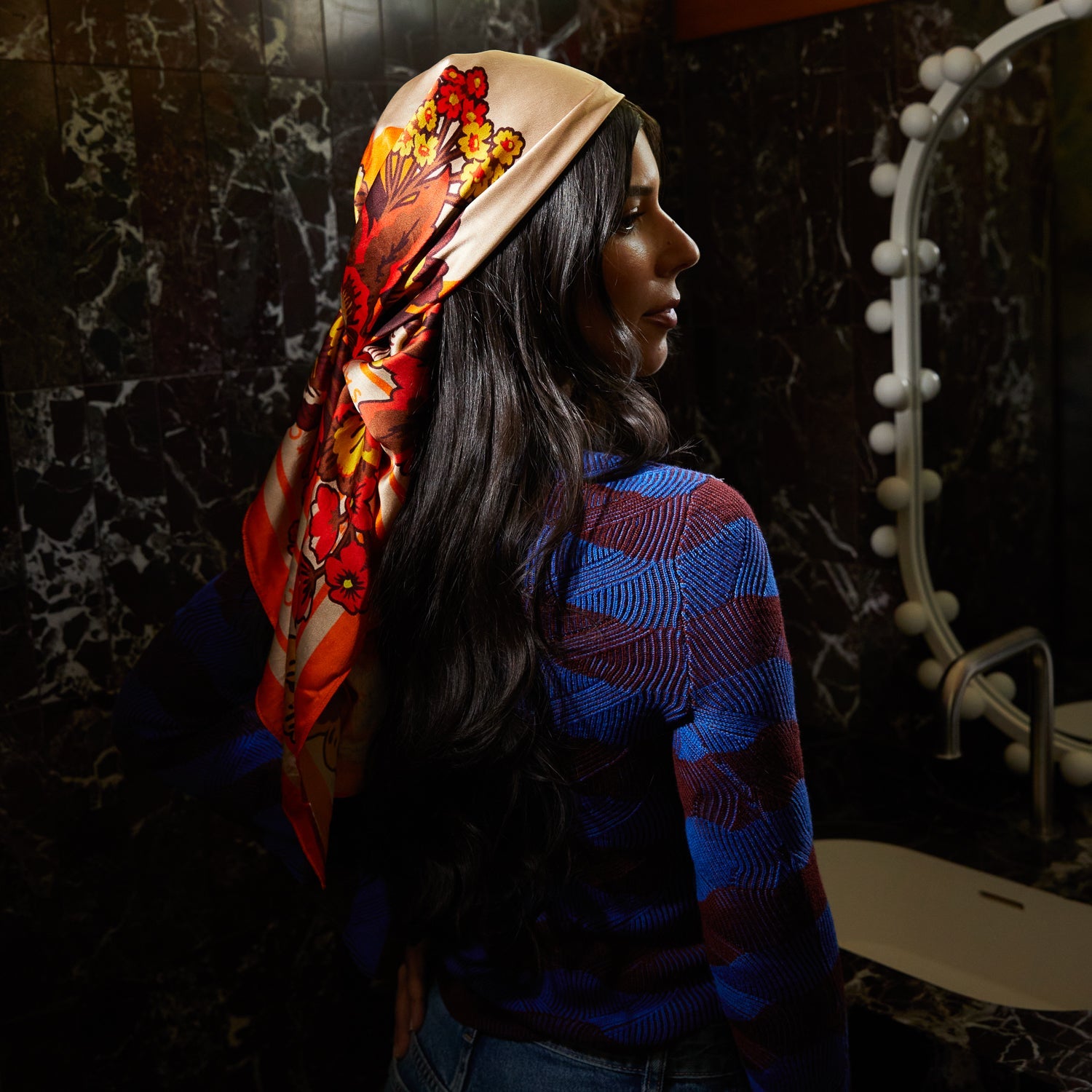 Profile view showing Eliza Silk Scarf worn as headband with floral pattern detail