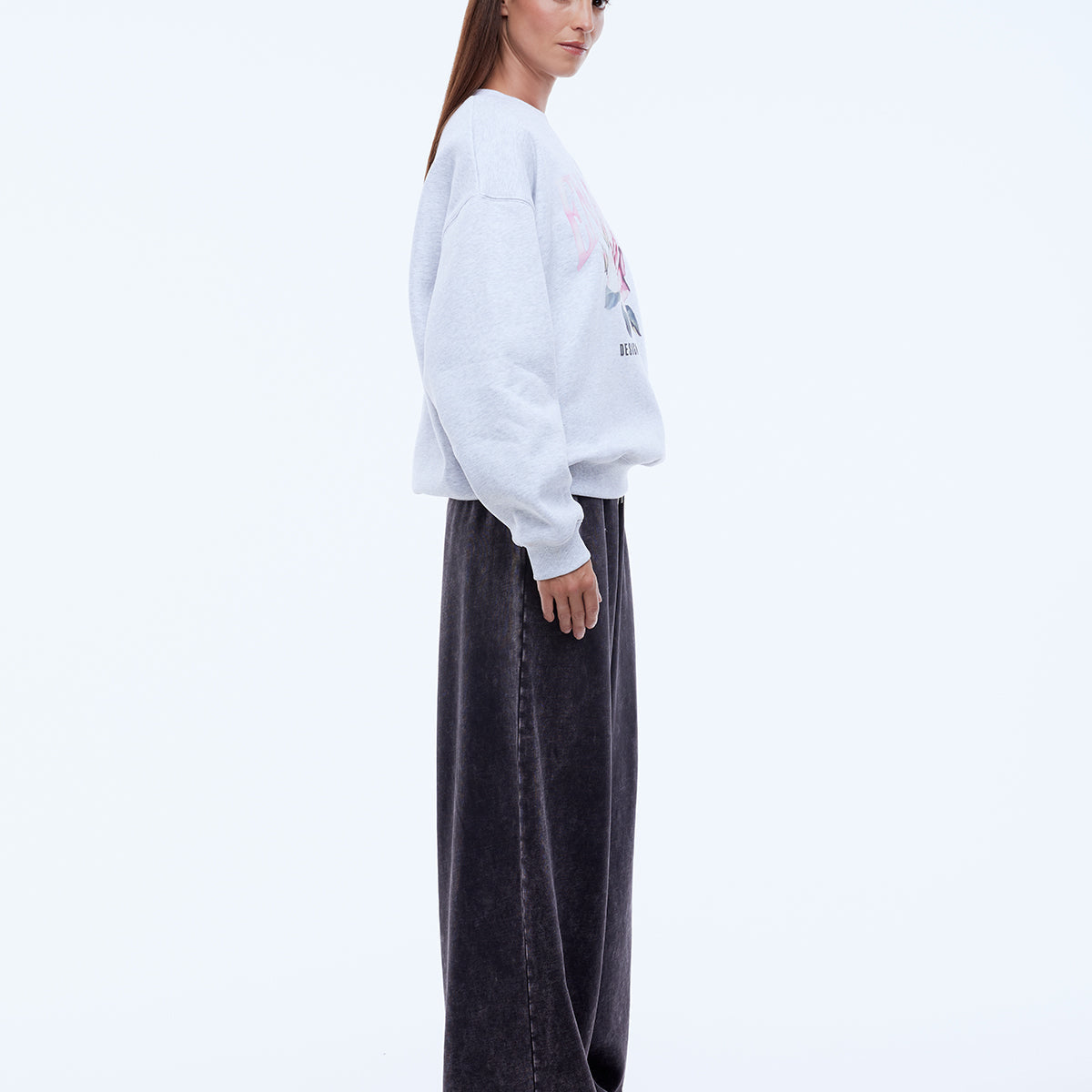 model wearing Ena Pelly Rose Sweatshirt styling shot showing crew neckline and rib cuff construction details