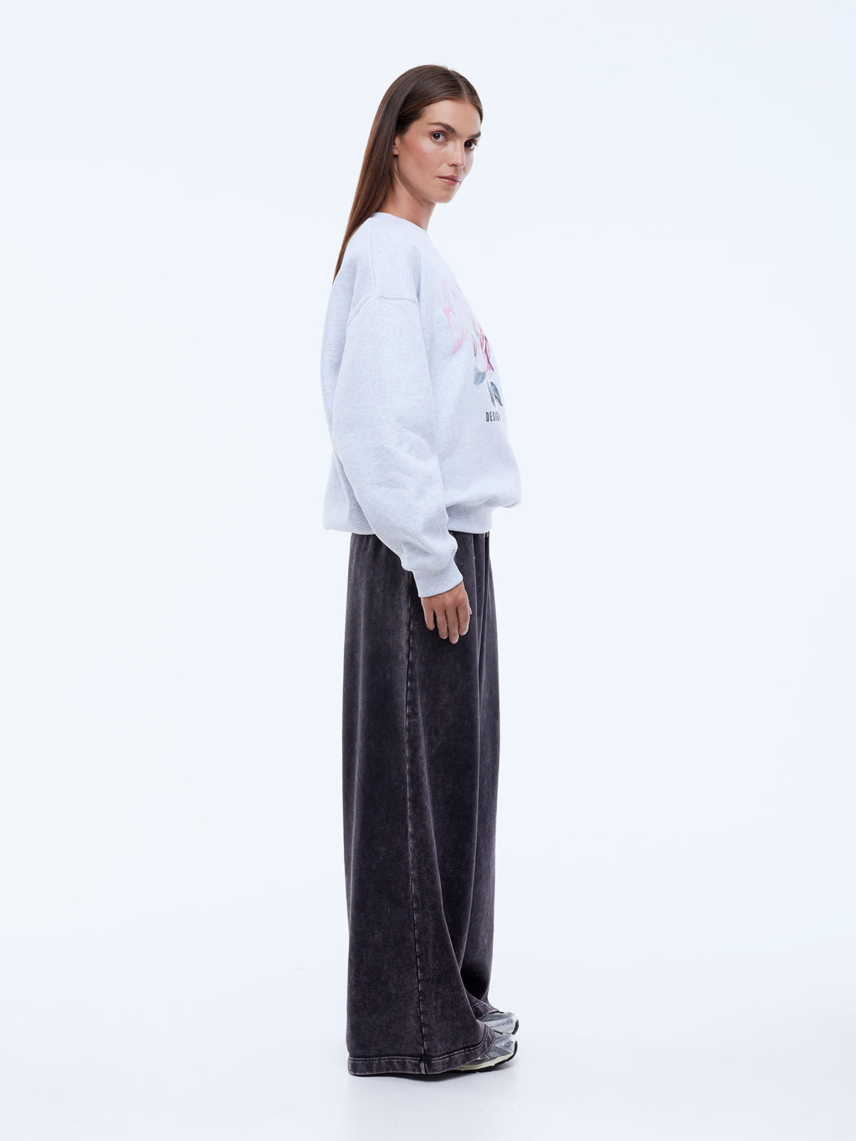 model wearing Ena Pelly Rose Sweatshirt styling shot showing crew neckline and rib cuff construction details