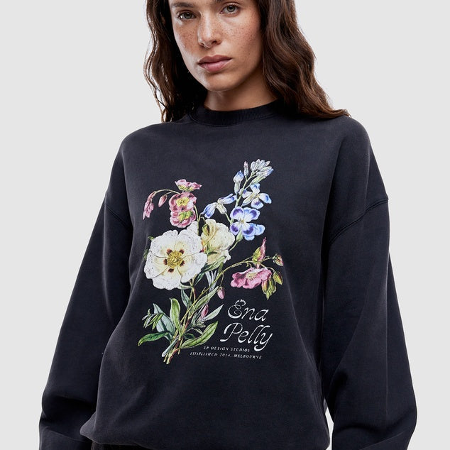 Woman wearing Ena Pelly black vintage bouquet hoodie showing relaxed oversized fit and drop shoulder styling