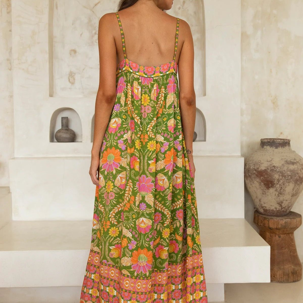 Back view of Nine Lives Bazaar Estella midi dress showcasing flowy silhouette and ruffle hem detail