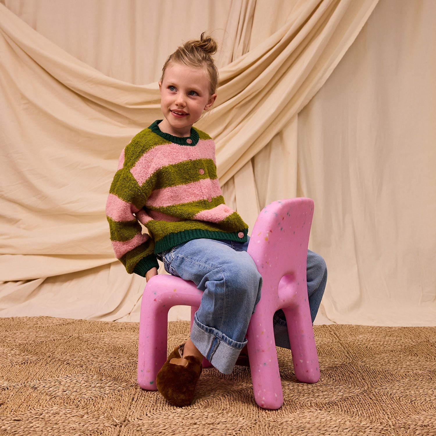 Child wearing Estrid Kids Cardigan in Blush by Sage & Clare with pink and green striped boucle knit wool blend
