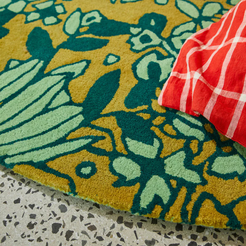 Close up details of Evette carpet rug by Sage & Clare - green floral pattern wool rug