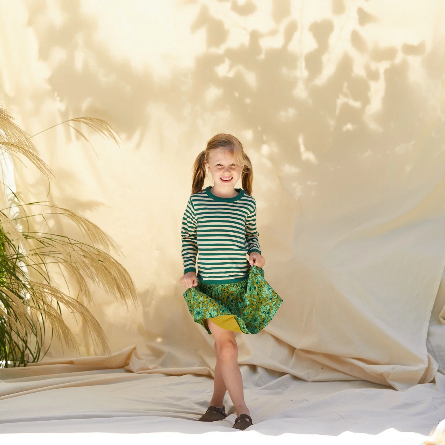 girl wearing Evette kids skirt - martini by Sage & Clare - green floral skirt