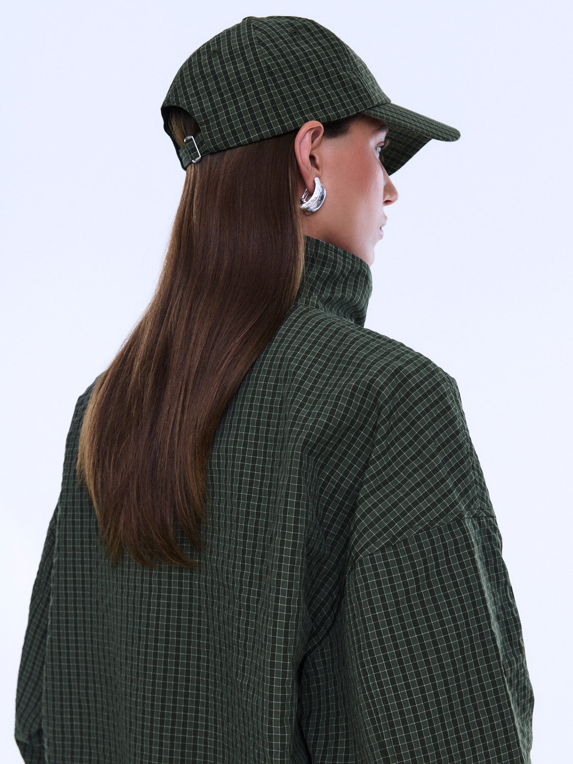 Side profile view of Fallon Check Cap showing curved brim and olive green check fabric detail