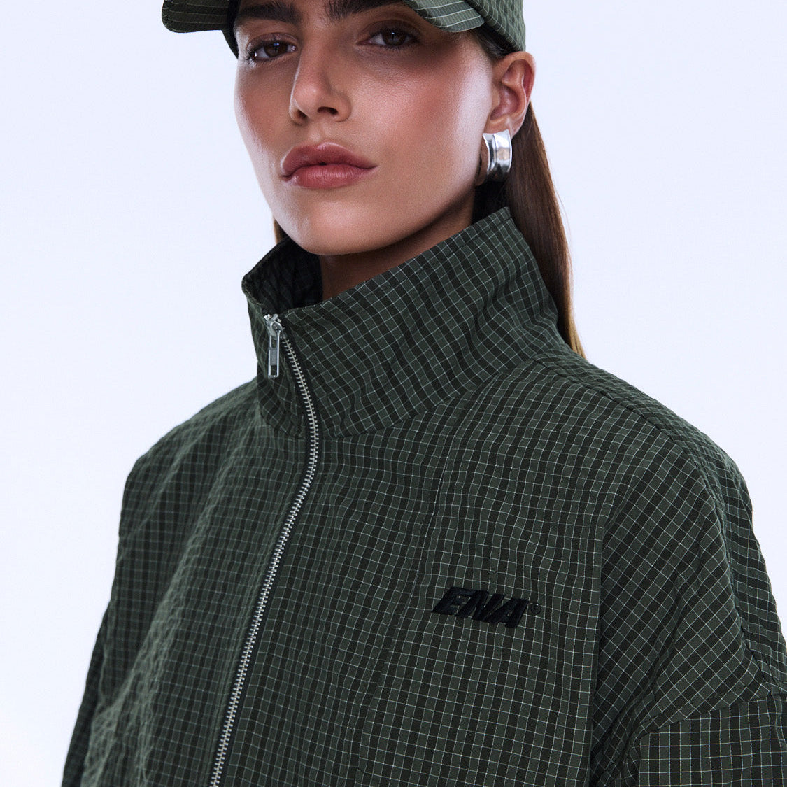 Close-up front view of Fallon Zip Thru Jacket showing olive check fabric texture and zipper detail