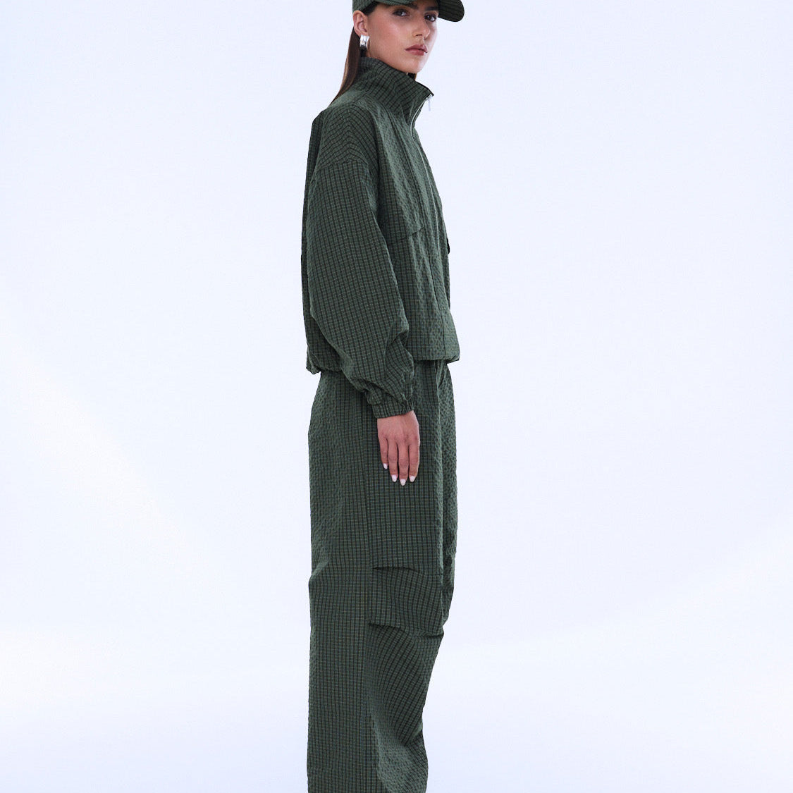 Side profile view of Fallon Zip Thru Jacket in olive check with structured silhouette