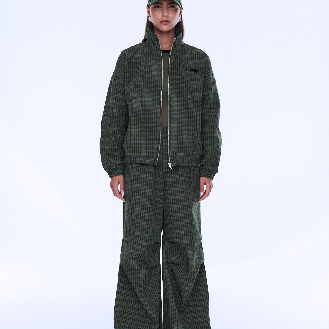 Front view of Fallon Zip Thru Jacket partially unzipped showing olive check pattern and fit