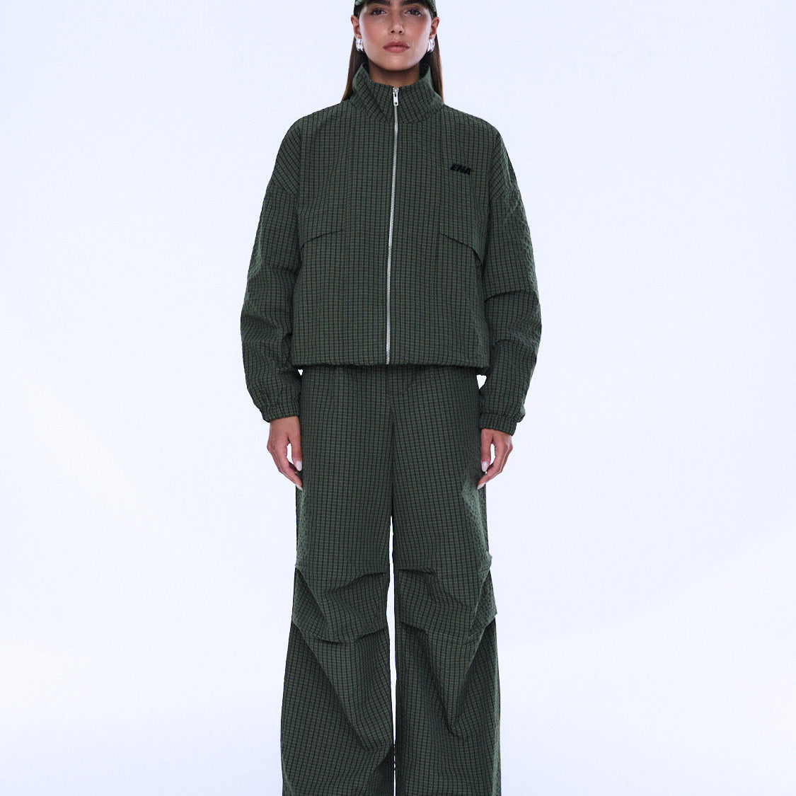 Front styling view of Fallon Zip Thru Jacket in olive check with high collar fully zipped