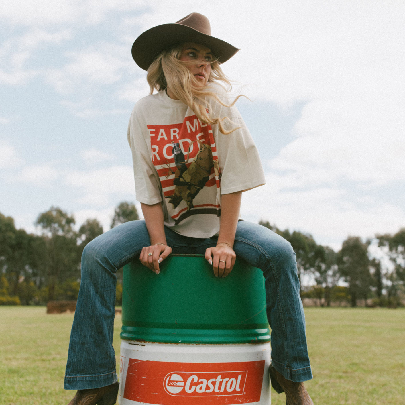 Back view of Rodeo Box Tee showing orange and white rodeo graphic with bull rider illustration