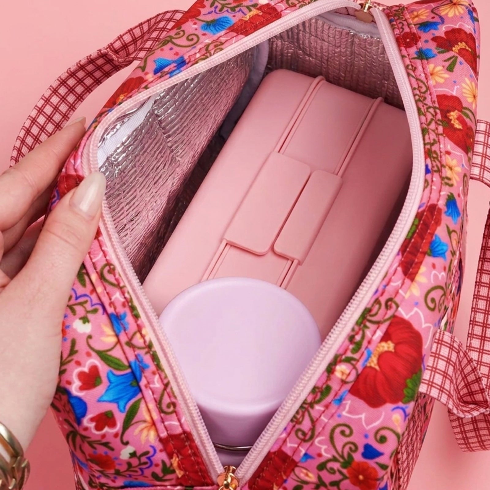 Interior view of opened Fable lunch tote showing insulated pink lining and ice pack compartments
