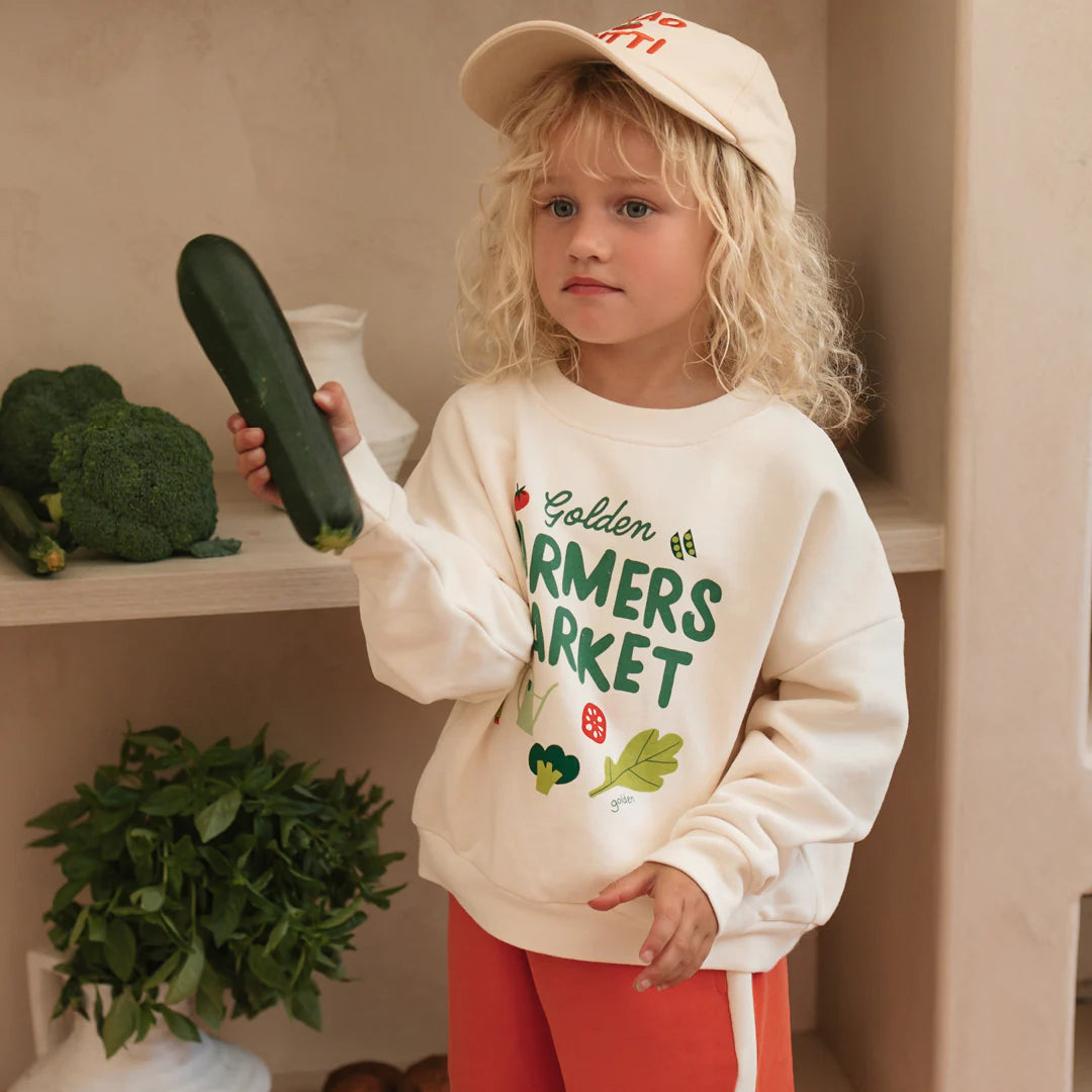 Farmers market Sweater Buttercream by Golden Children worn by child wearing ciao tutti cap
