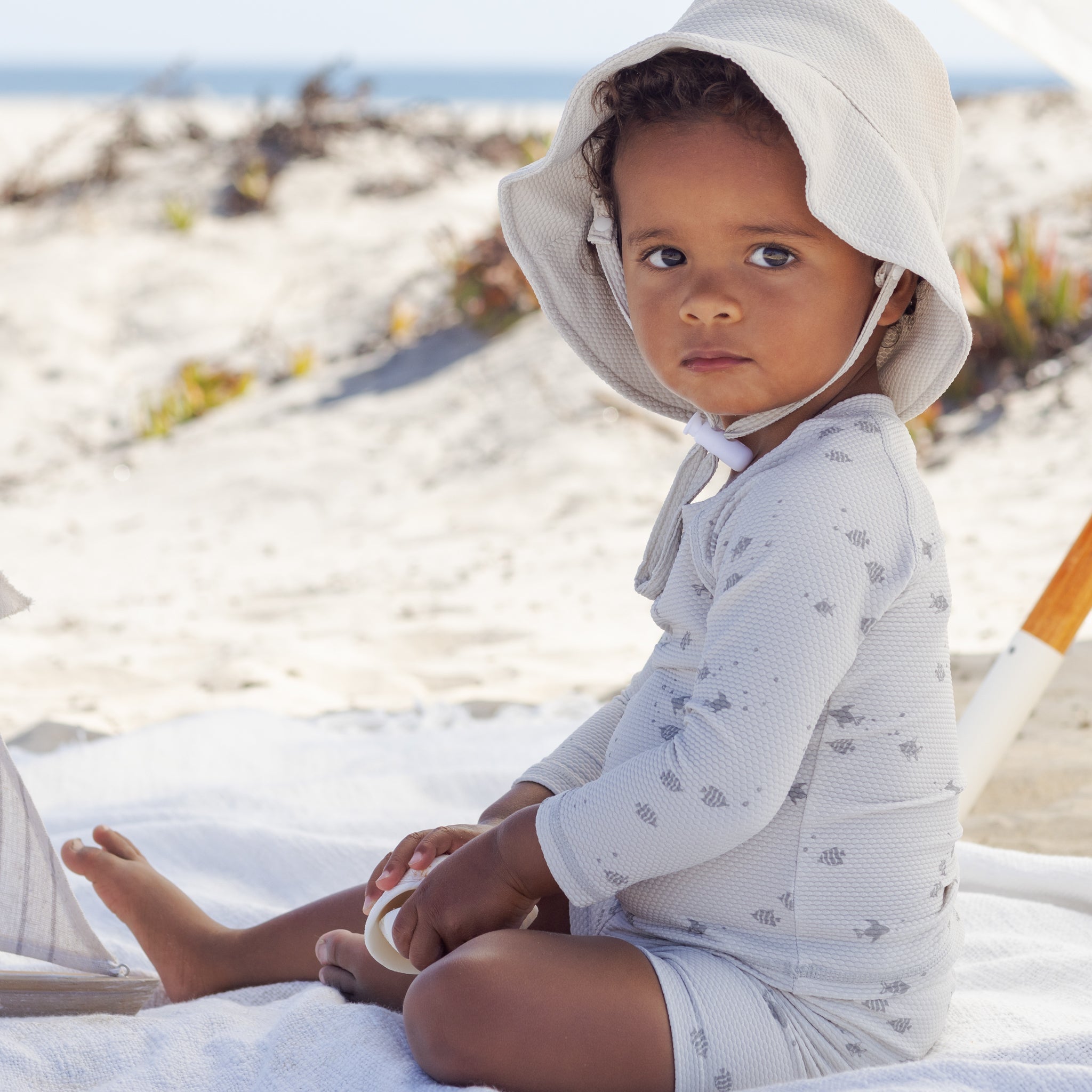 Boy in the Finn Rashguard + Short Set Fish | Quincy Mae at the beach