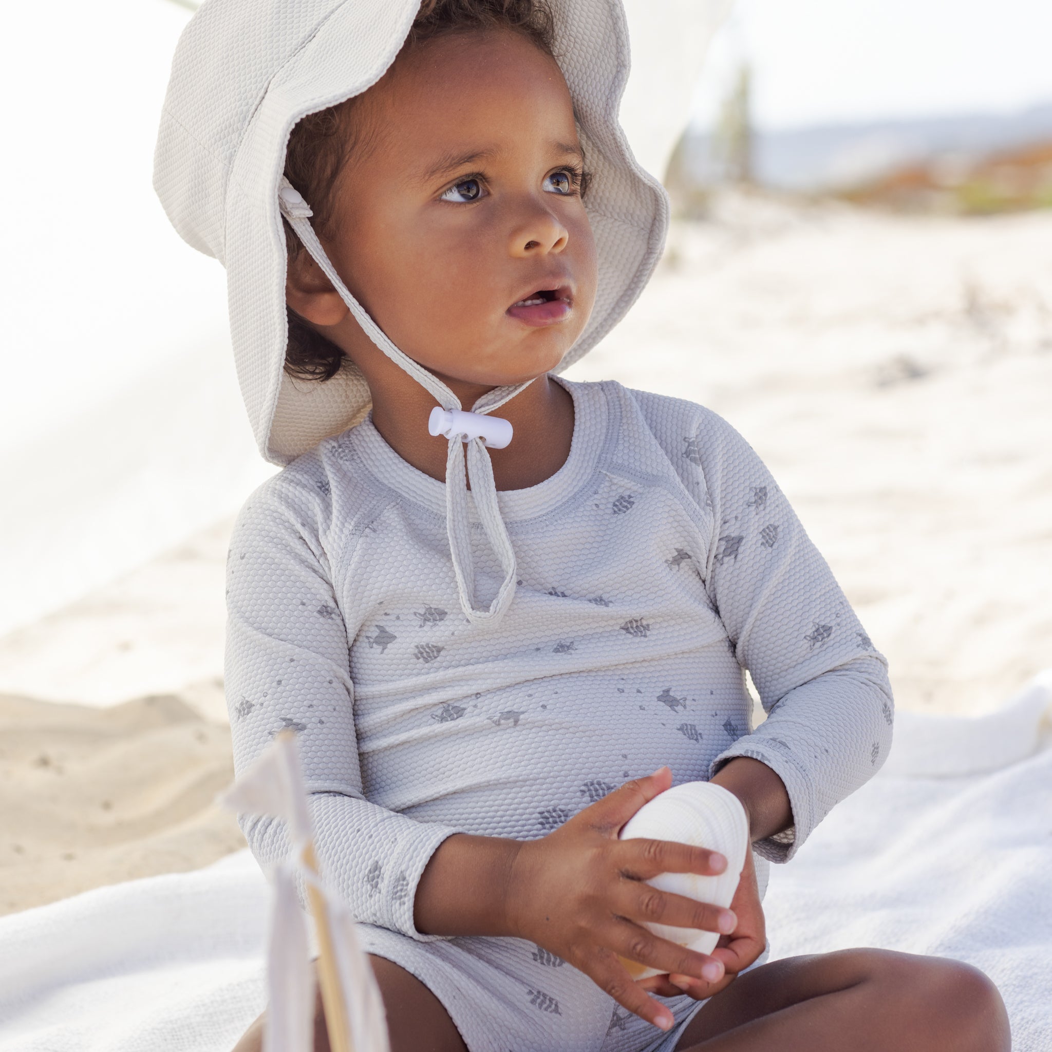 Young boy wearing the Finn Rashguard + Short Set Fish | Quincy Mae