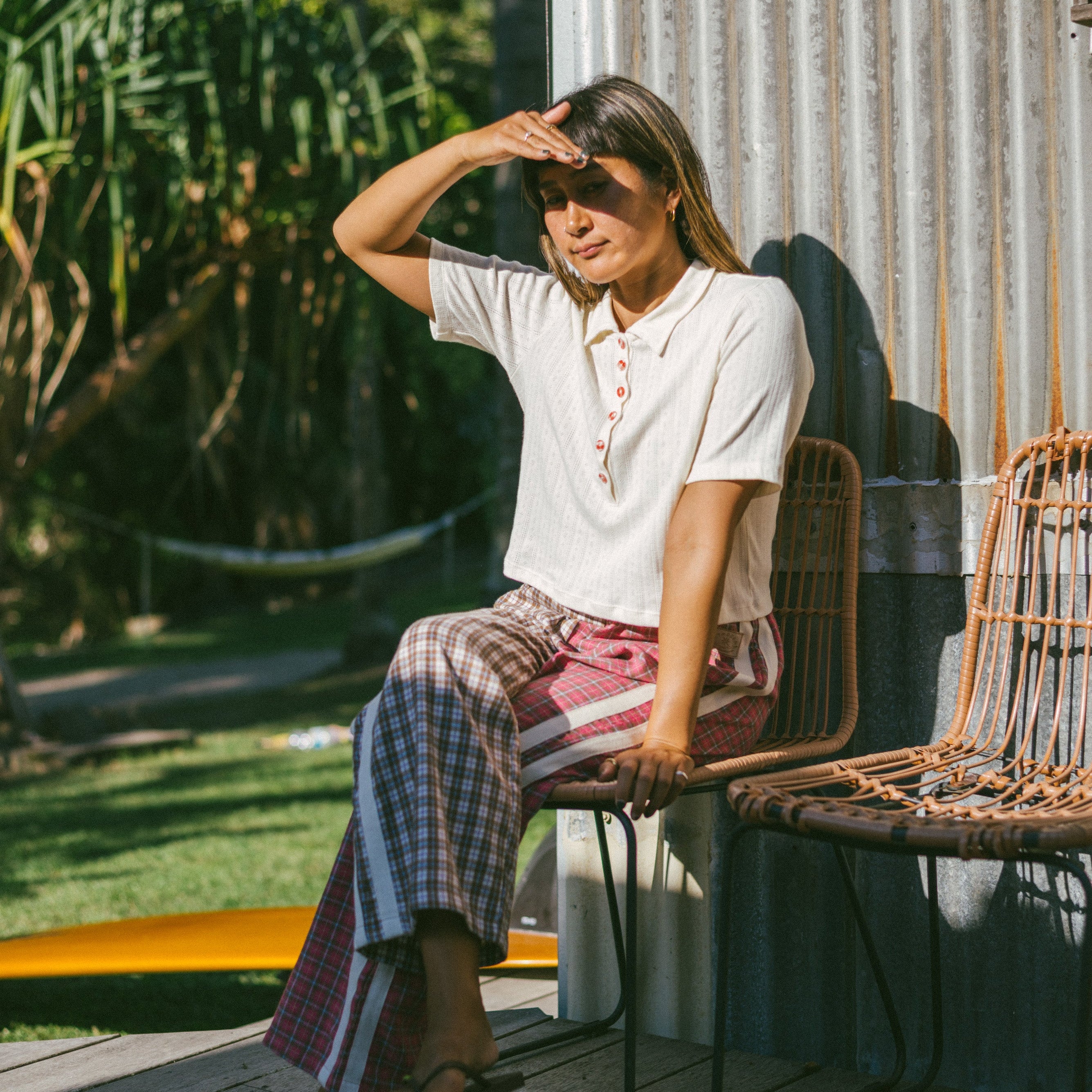 Lady sitting down wearing Flannel Flare Pant - Strawberry Pink by Atmosea