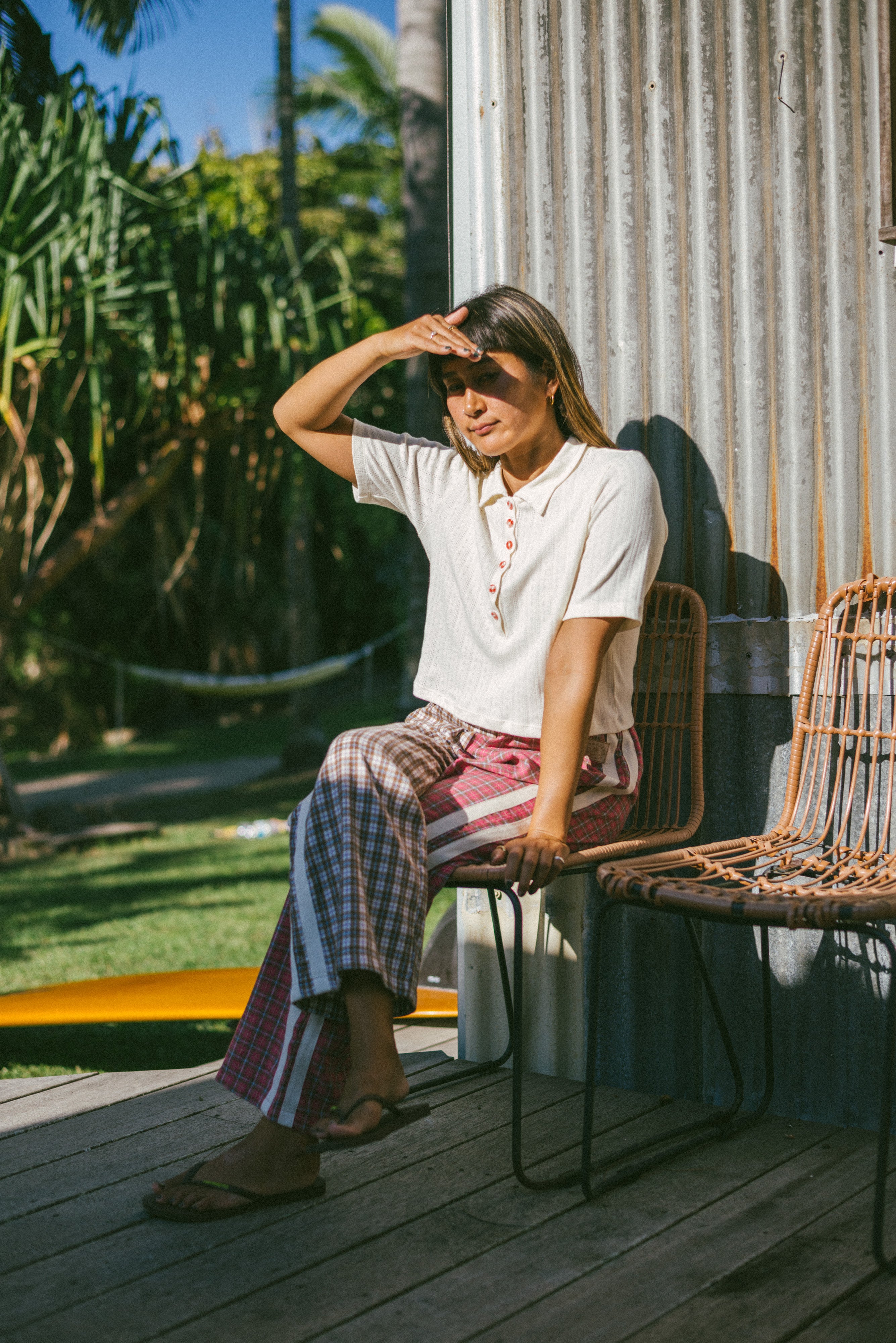 Lady sitting down wearing Flannel Flare Pant - Strawberry Pink by Atmosea