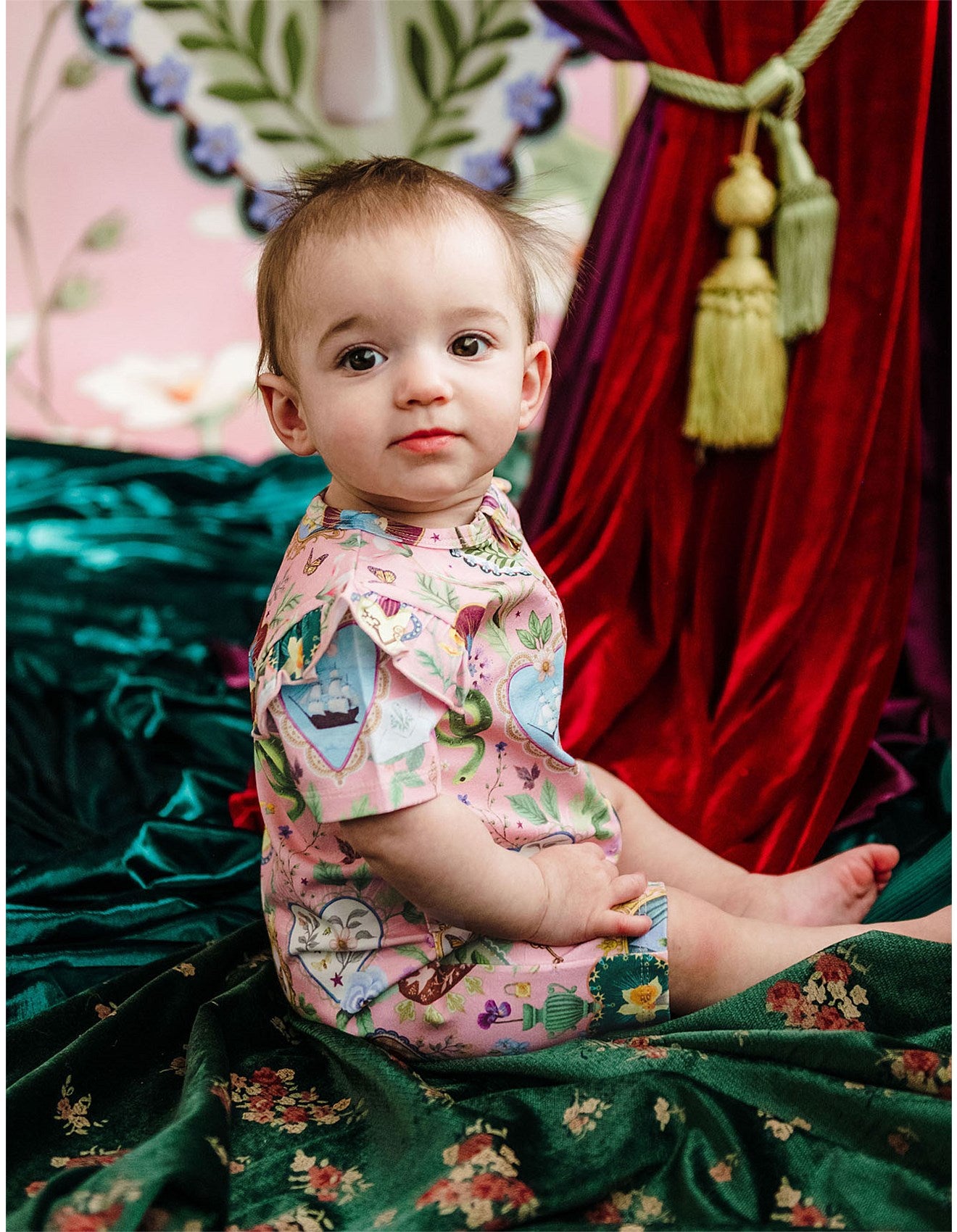 baby wearing pink baby onesie by Fleur Harris