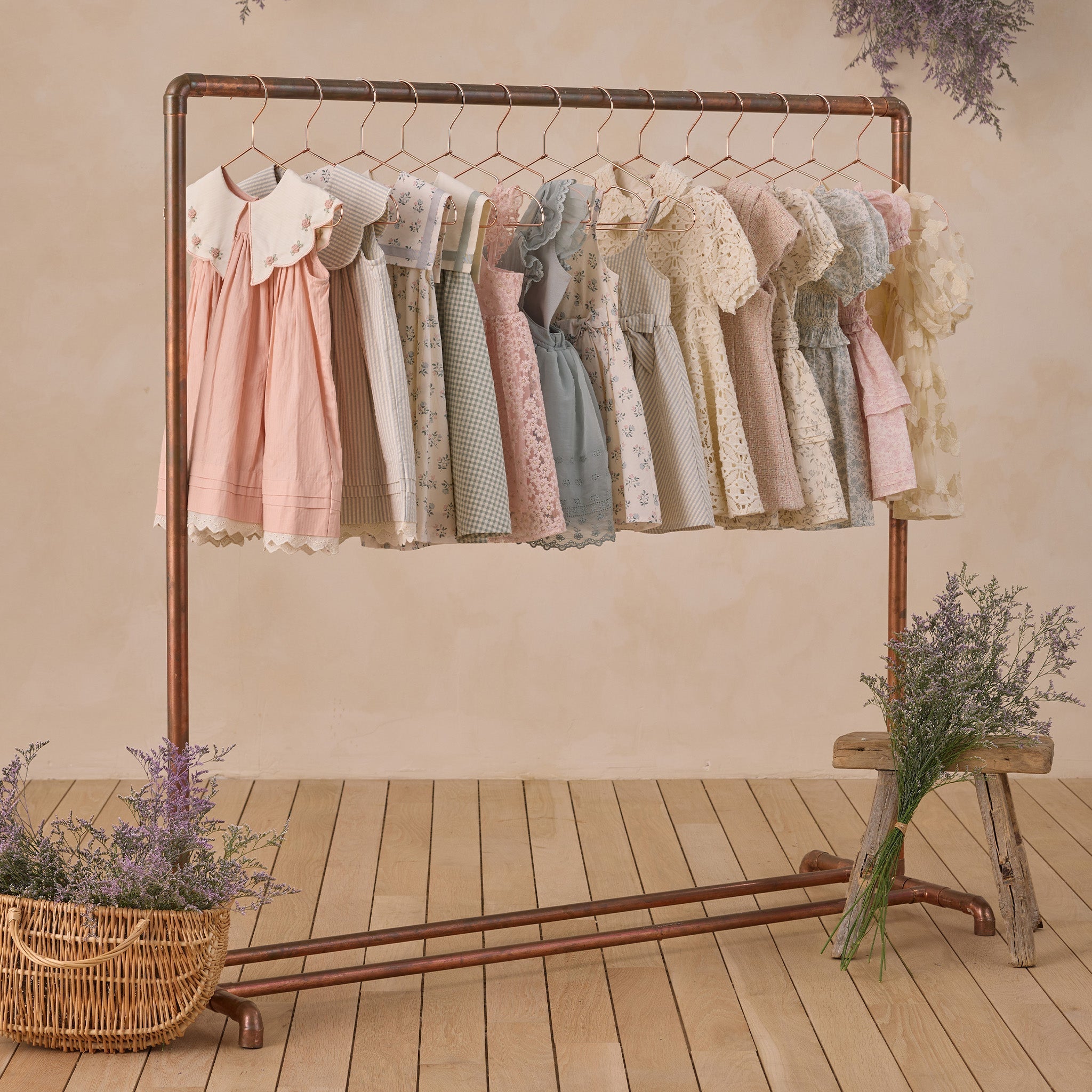 Florence Dress Sky Stripe displayed on clothing rack with other Noralee vintage-inspired dresses