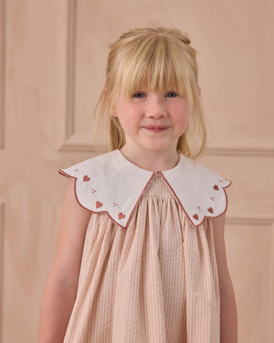 Close up of young girl wearing the Florence Dress - Petal | Noralee