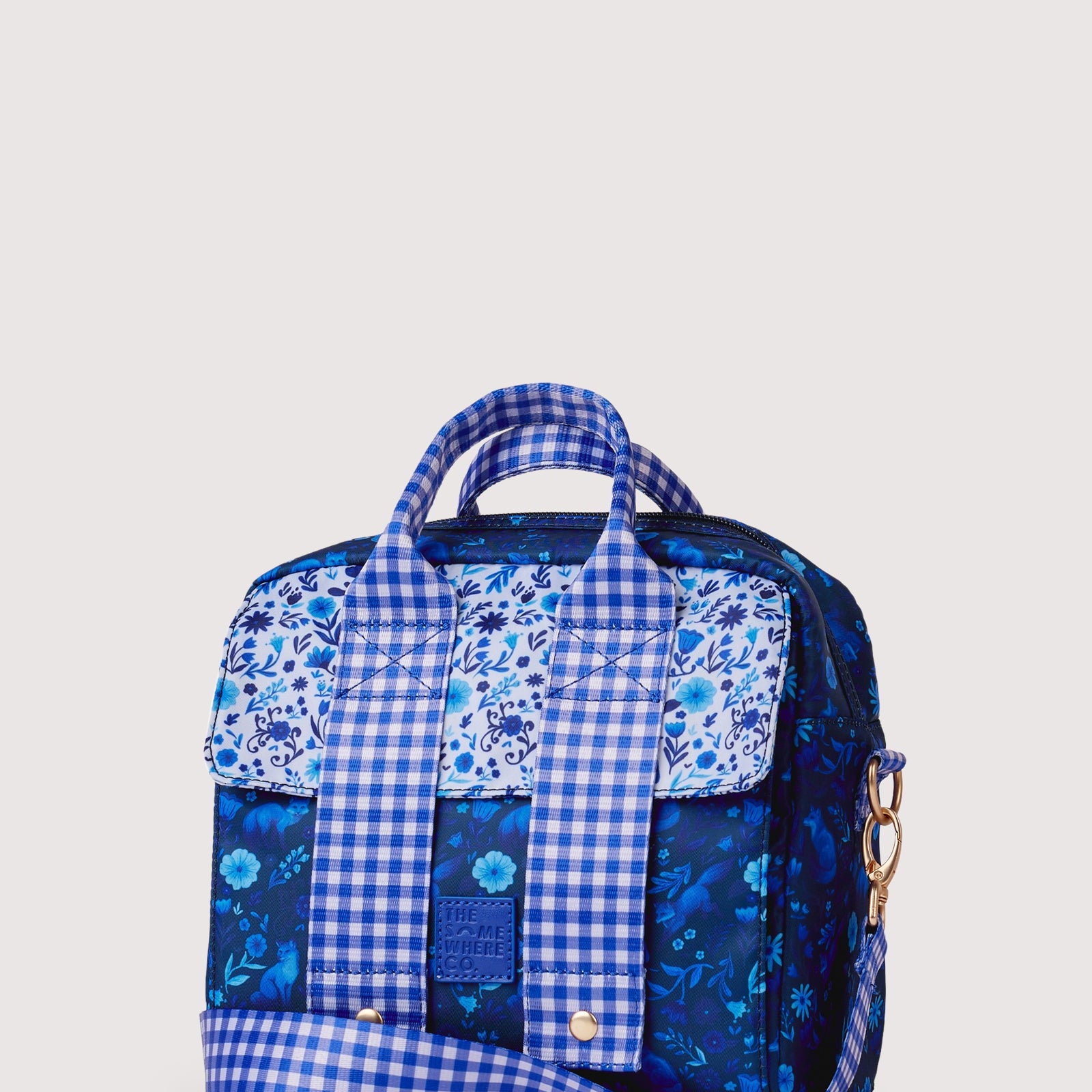 Front view of Foxwood lunch tote featuring blue gingham and floral patchwork design with gold snaps