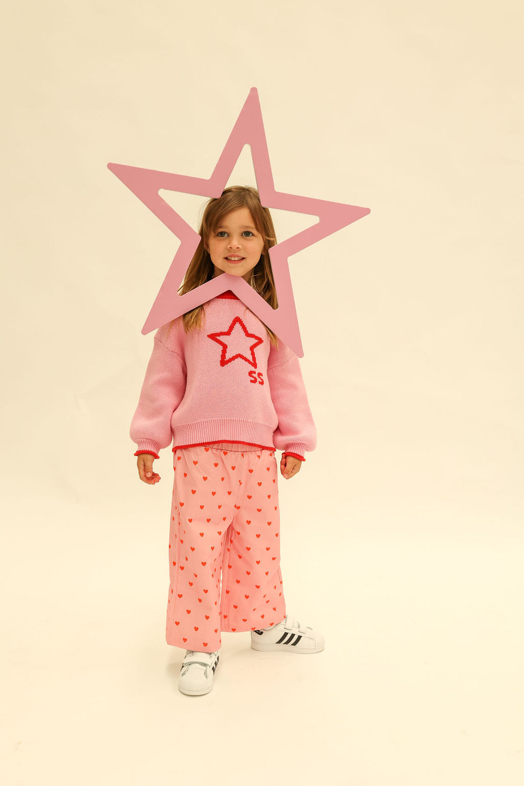 Full length view of pink Fruit Loop Pants Hearts with red heart print and wide leg silhouette