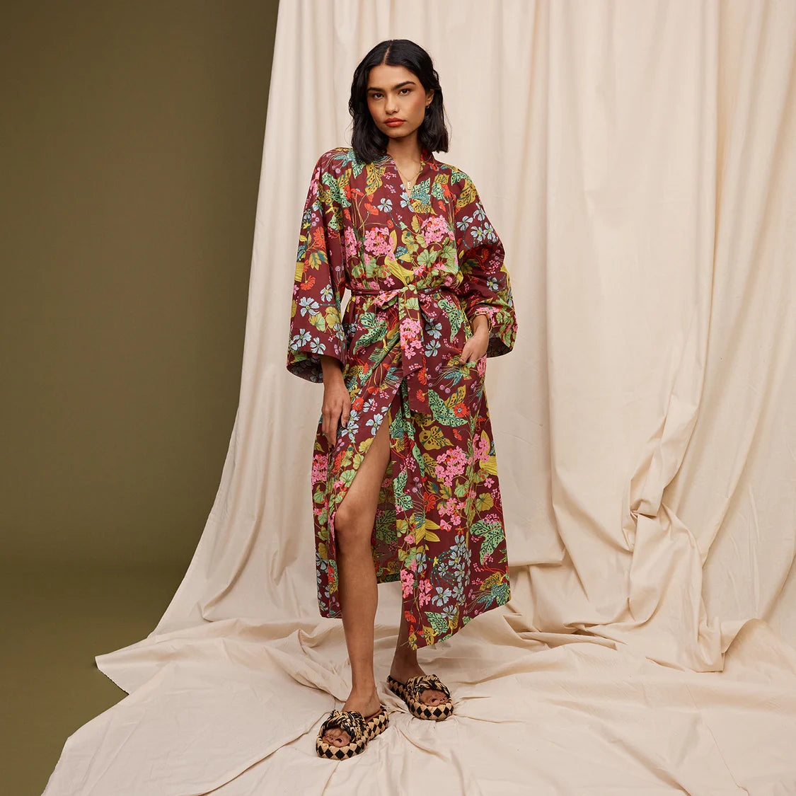 Woman wearing colorful Genevieve cotton bathrobe relaxing at home in luxurious comfort