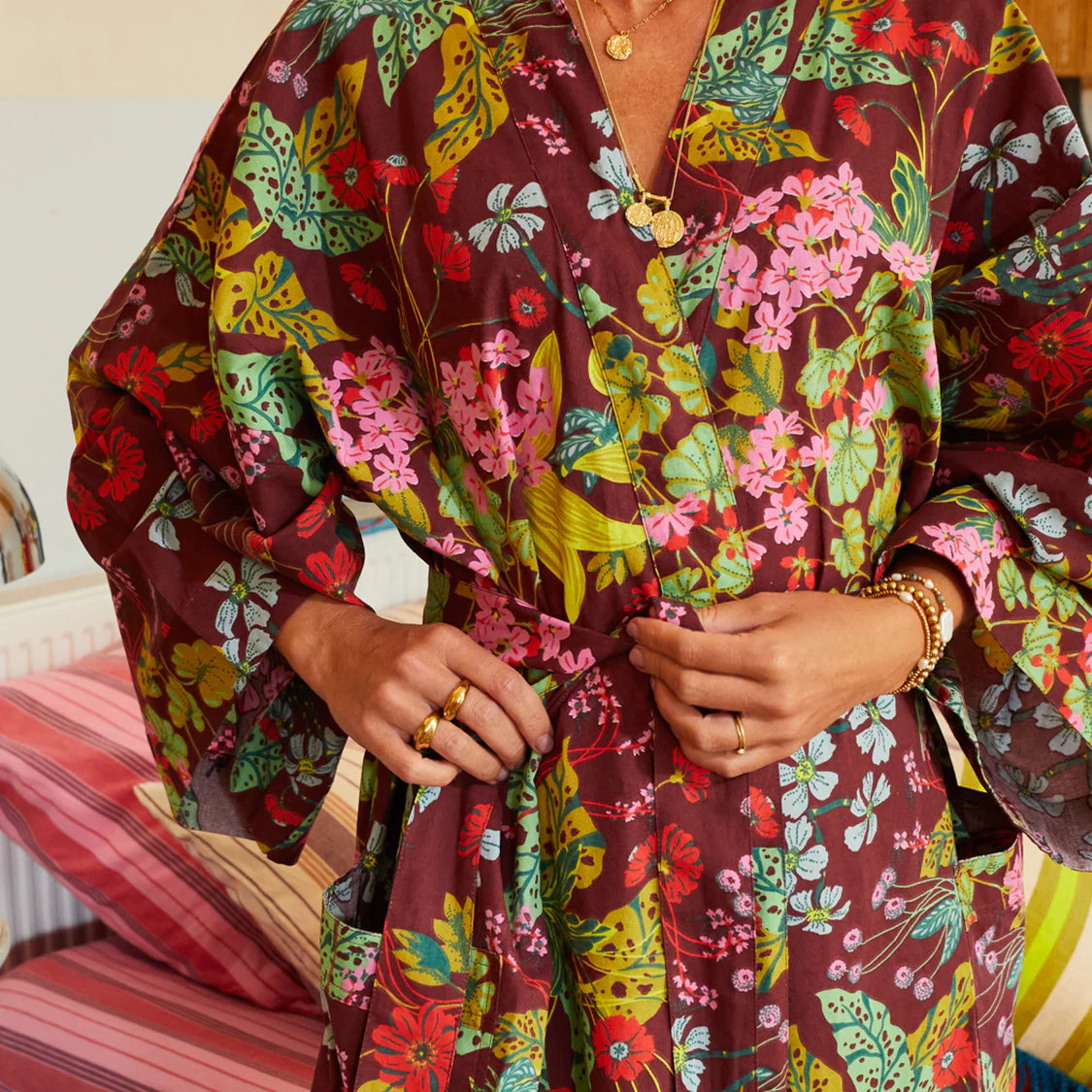 Close up detail of Genevieve robe wide bell sleeves and vibrant pattern design