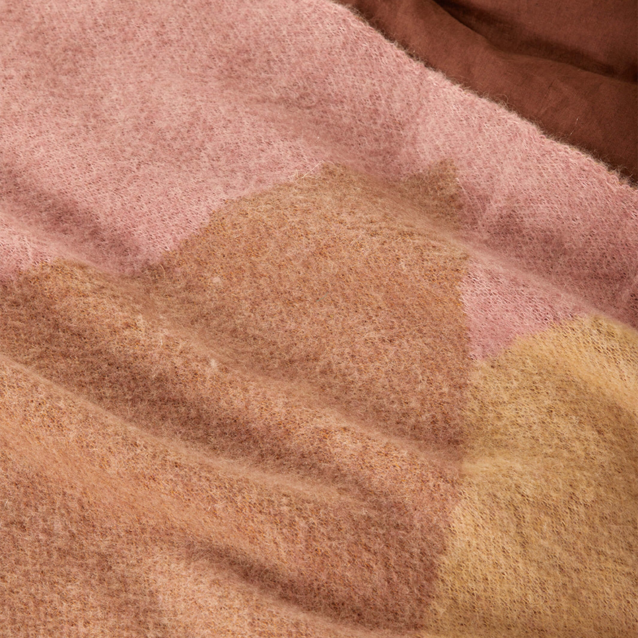 Detail view of mohair fabric texture showing pink and brown geometric pattern