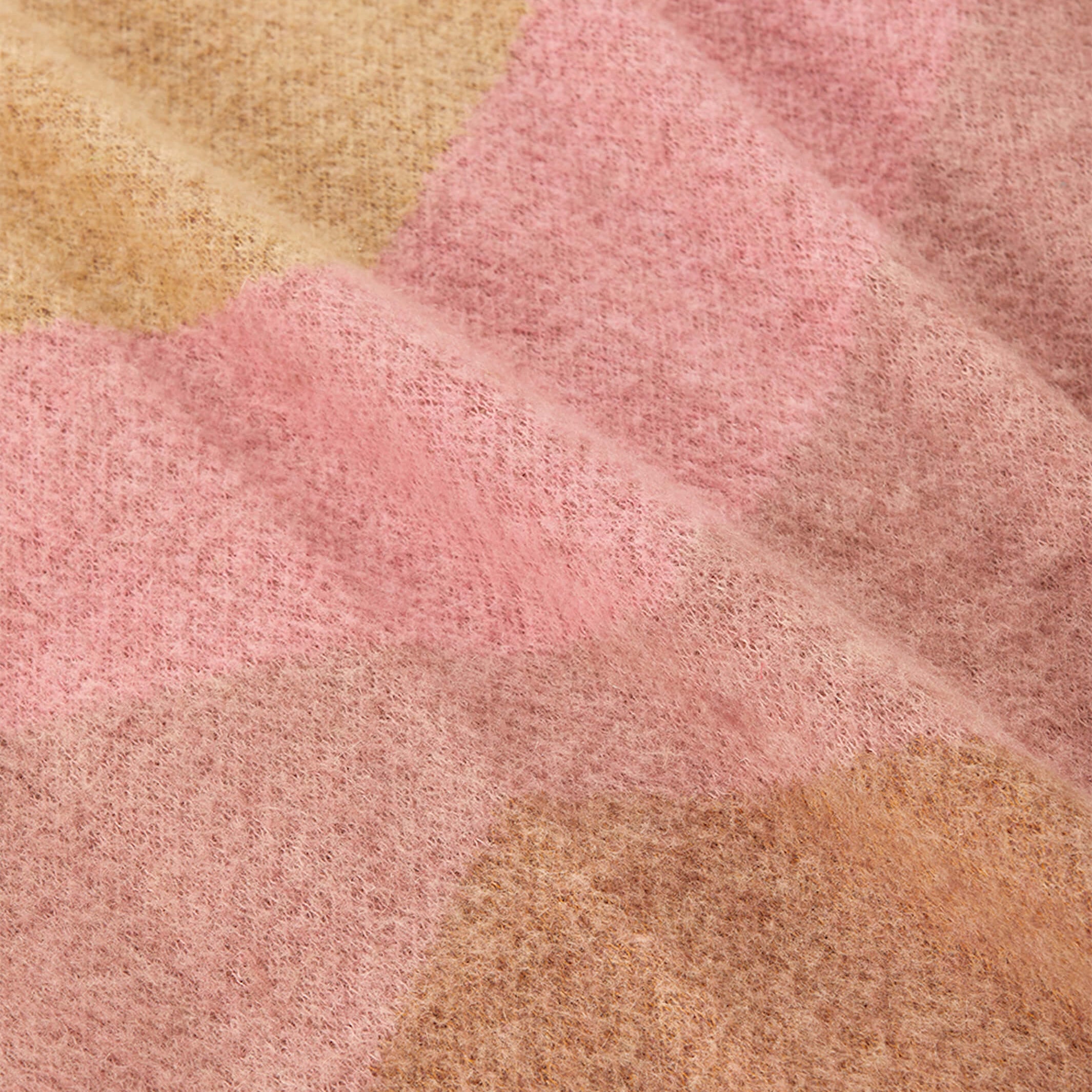 Extreme close-up of mohair weave texture in pink and camel geometric design