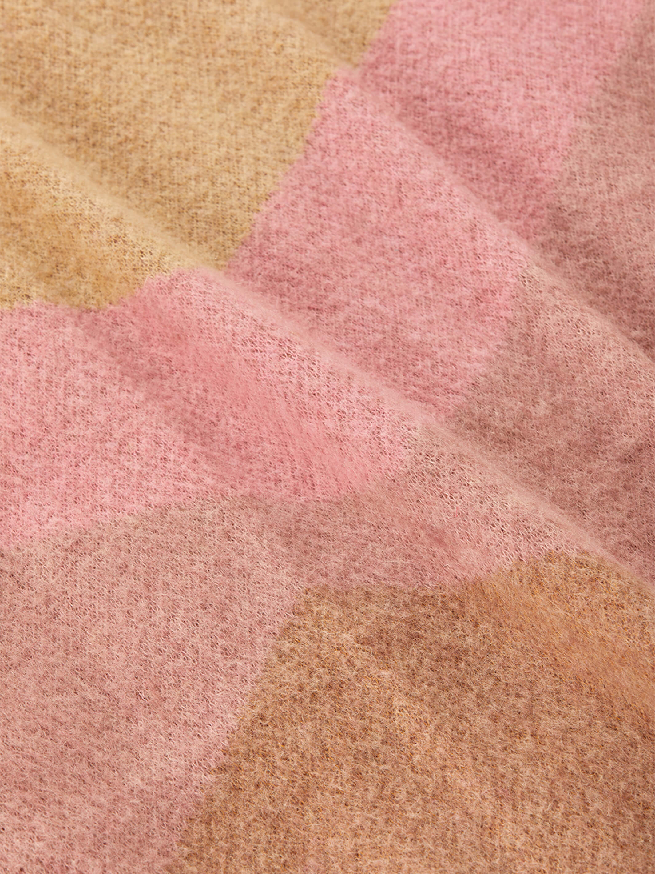 Extreme close-up of mohair weave texture in pink and camel geometric design