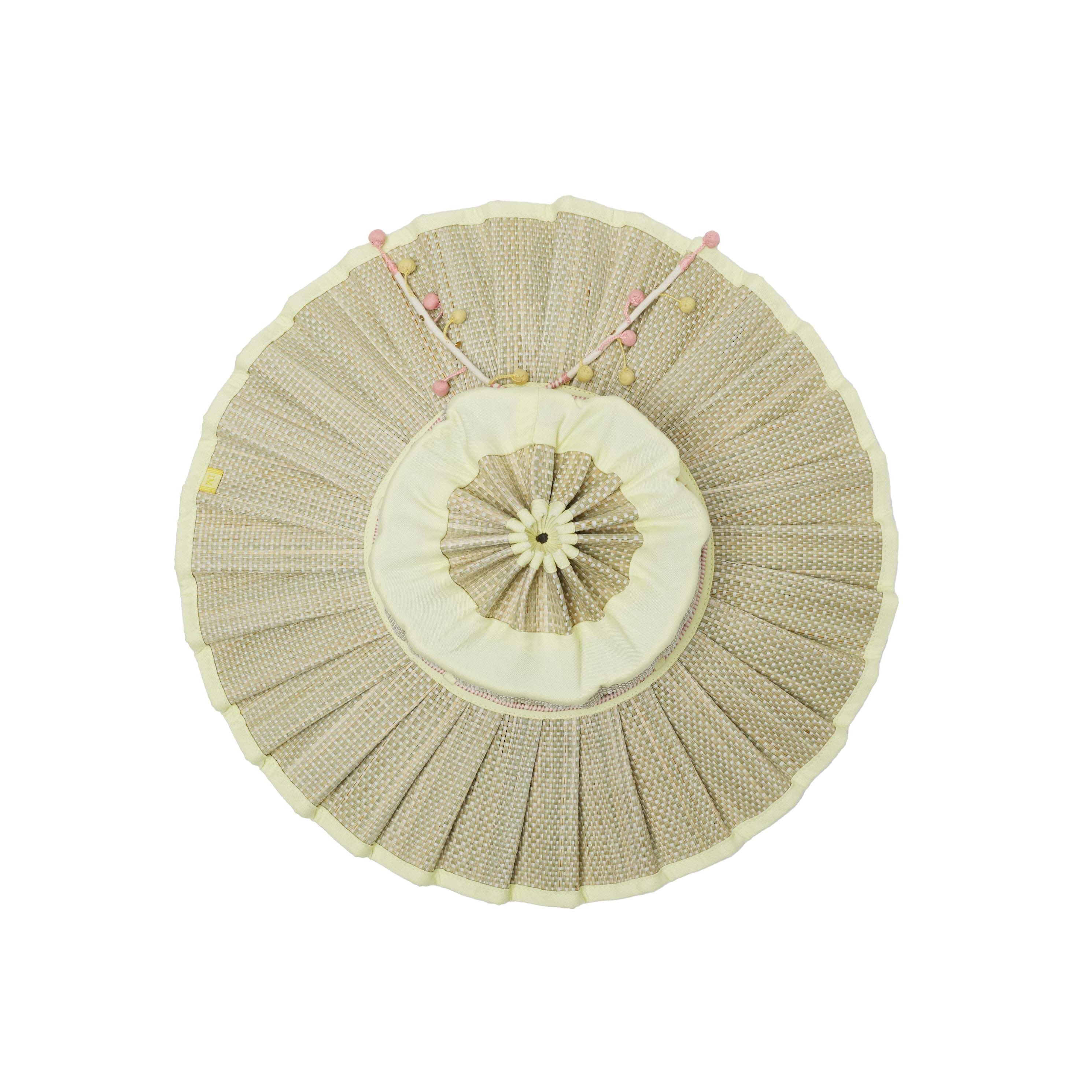 Flat lay top view of Lorna Murray Godesis Capri Play hat showing radial pleating pattern and adjustable chin ties