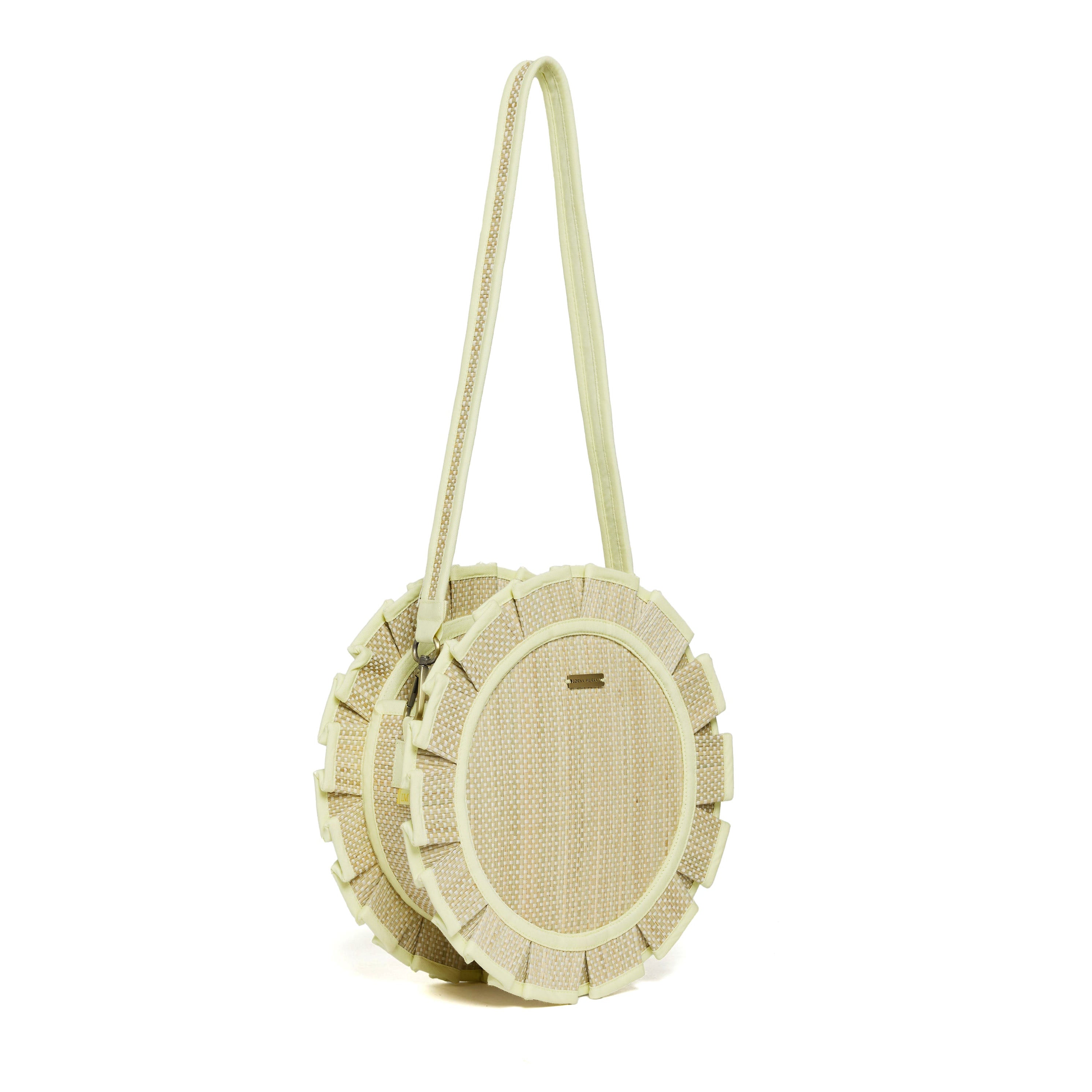 Side angle view of Godesis Mini Love Note Tote showing circular shape and braided shoulder strap detail