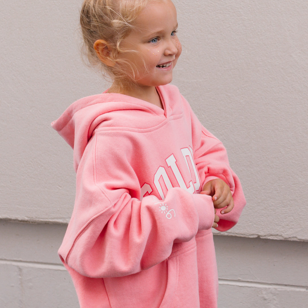 Side view of young girl wearing the Golden Hoodie - Pink Icing | Golden Children