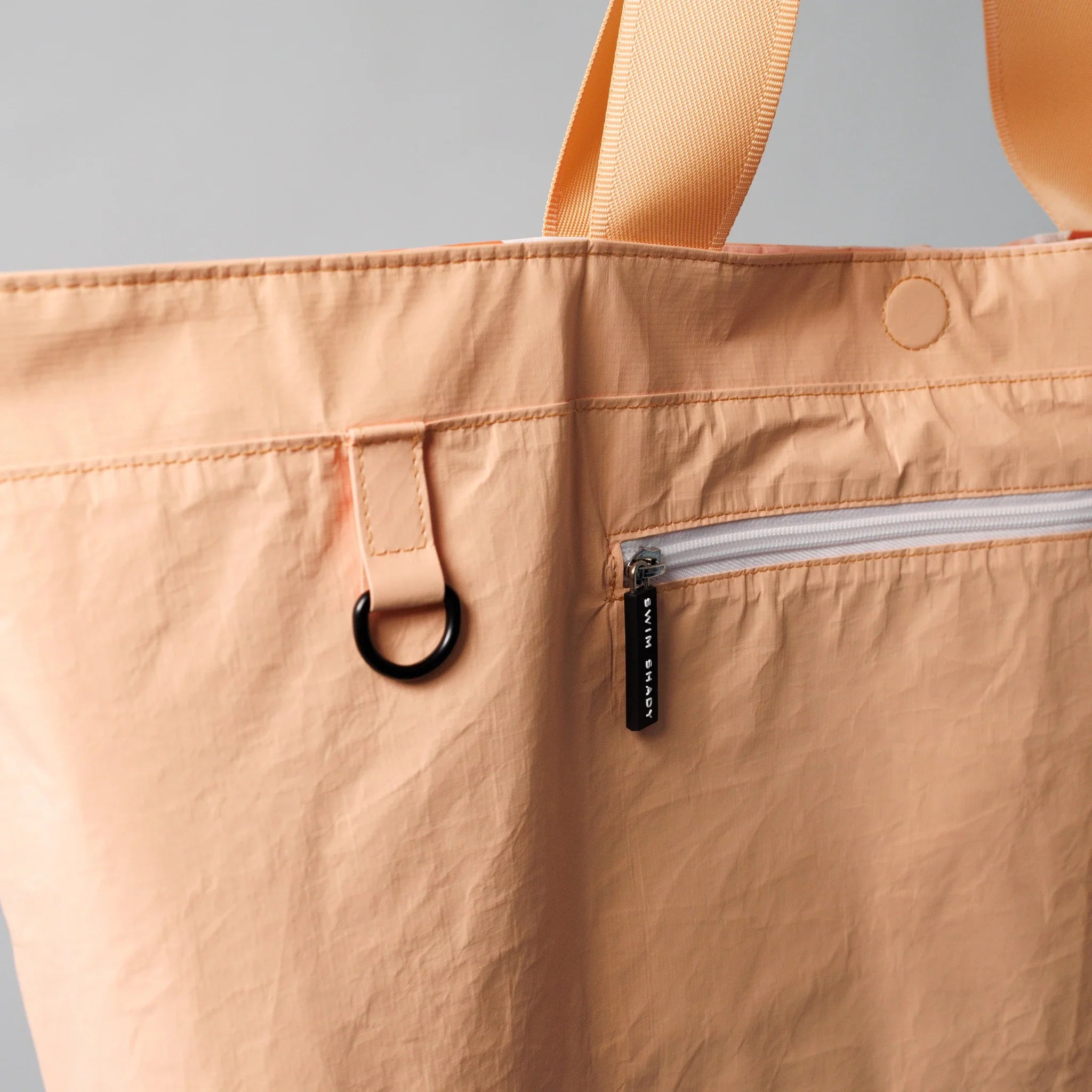inside pocket detail of orange Tyvek swim bag by Swim Shady