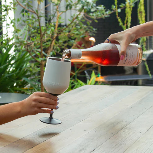 Person pouring wine into a Huski Wine Tumbler
