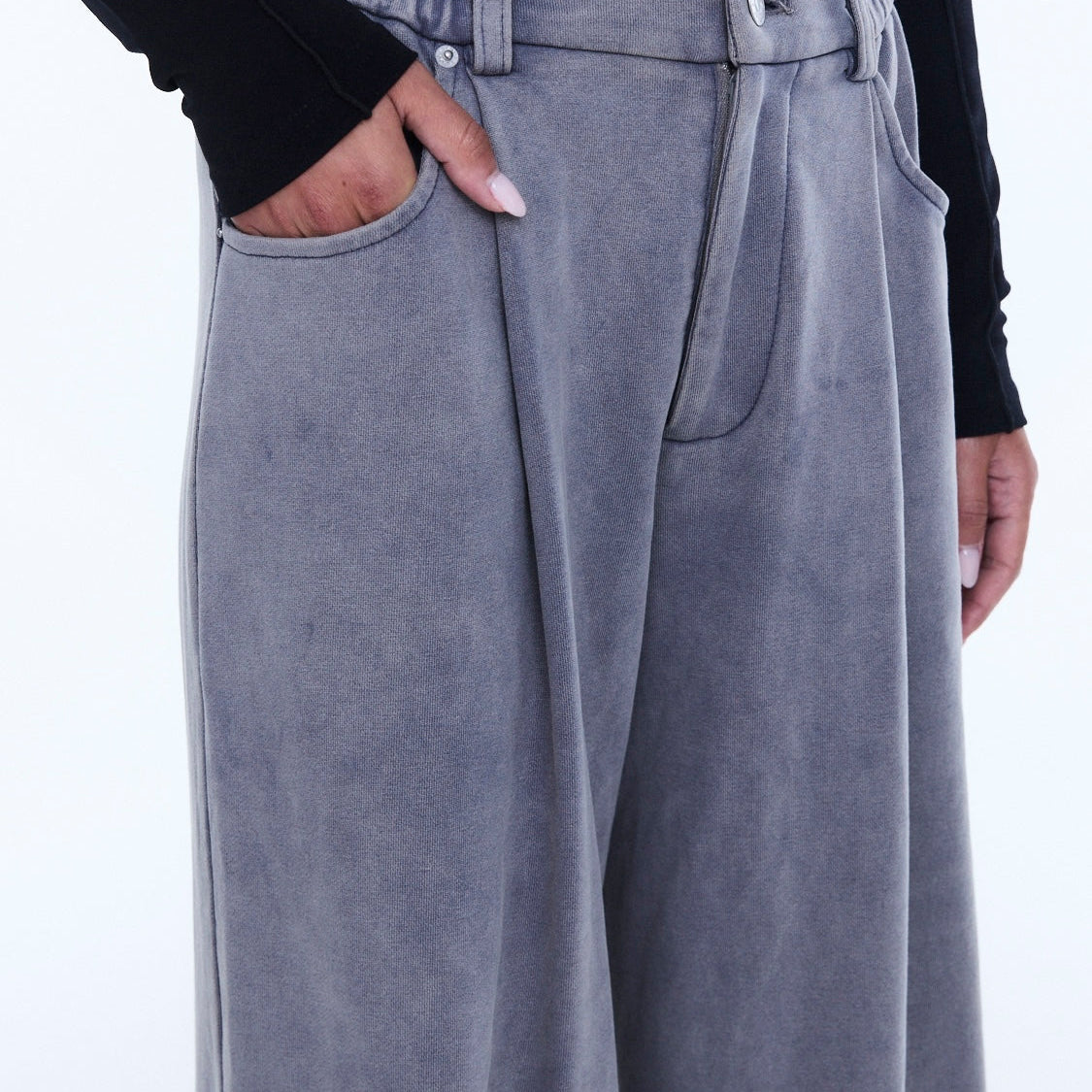 Close-up detail of dove grey jersey pant waistband showing elastic gathering and front pocket