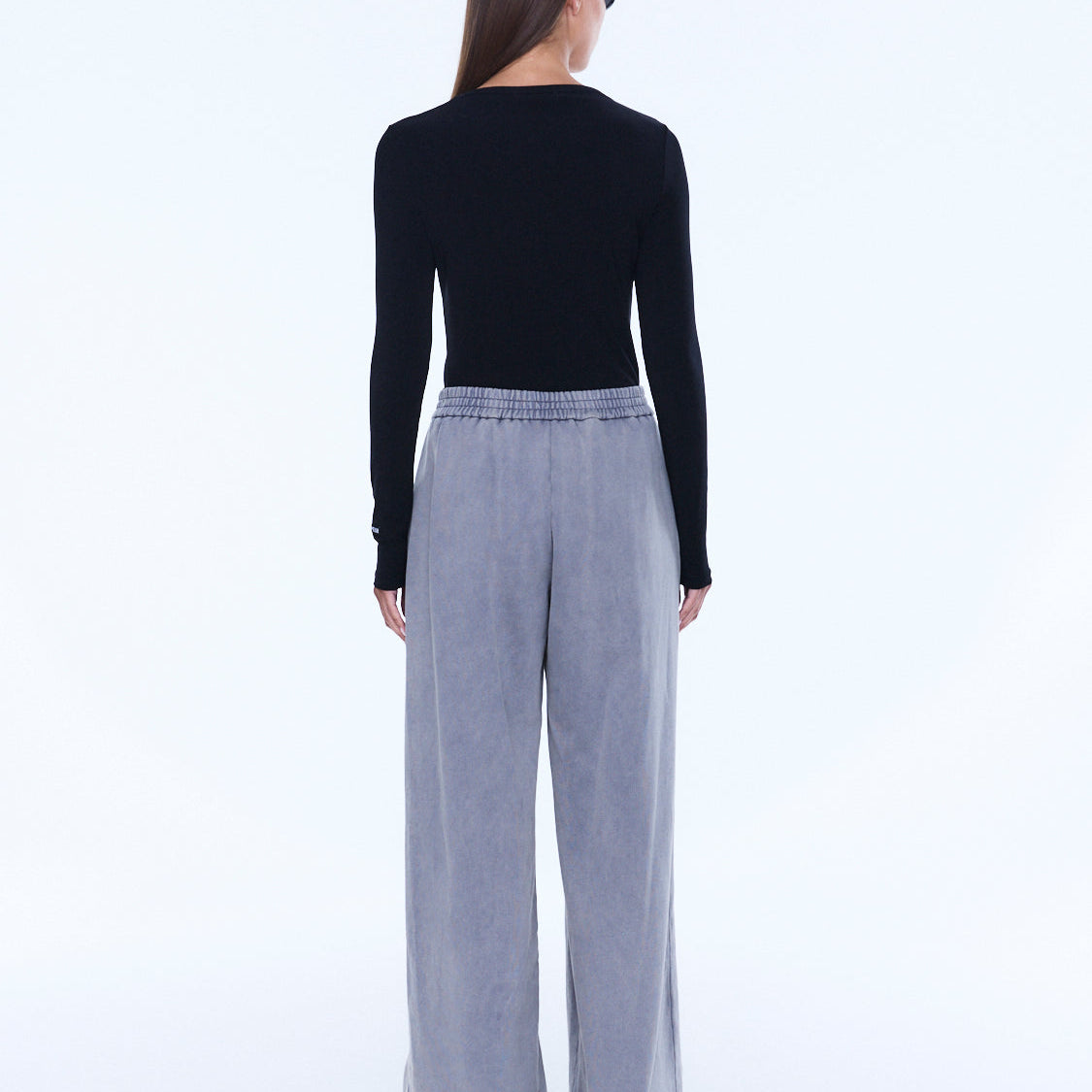 Back view of dove grey jersey wide leg pants showing elastic waistband and cuffed hem