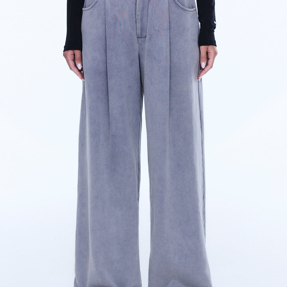 Front view detail of dove grey jersey pants showing button closure and wide leg silhouette